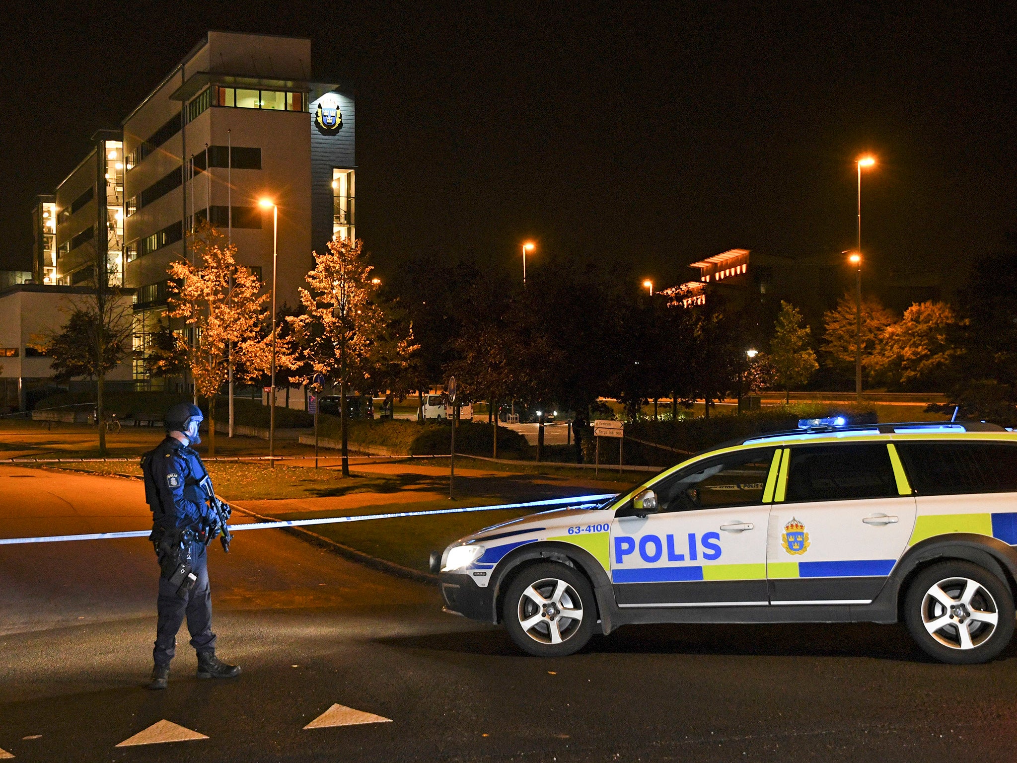 A police officer stands guard outside the roped off area surrounding the police station in Helsingbor