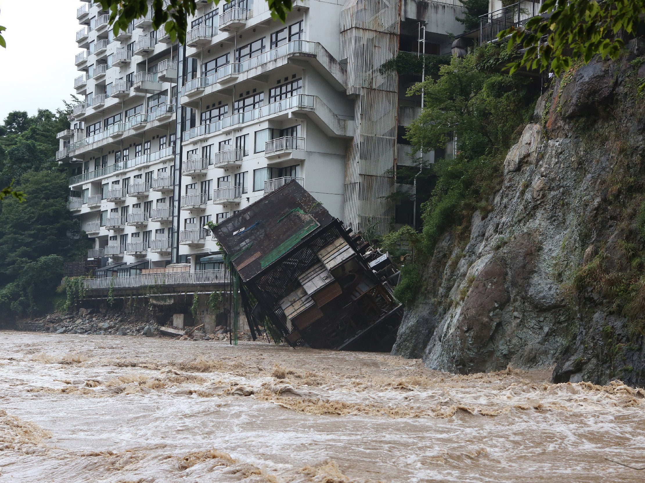 A hotel building falls into the floodwaters at Nikko mountain resort in Tochigi prefecture near Tokyo after torrential rain on 10 September, 2015