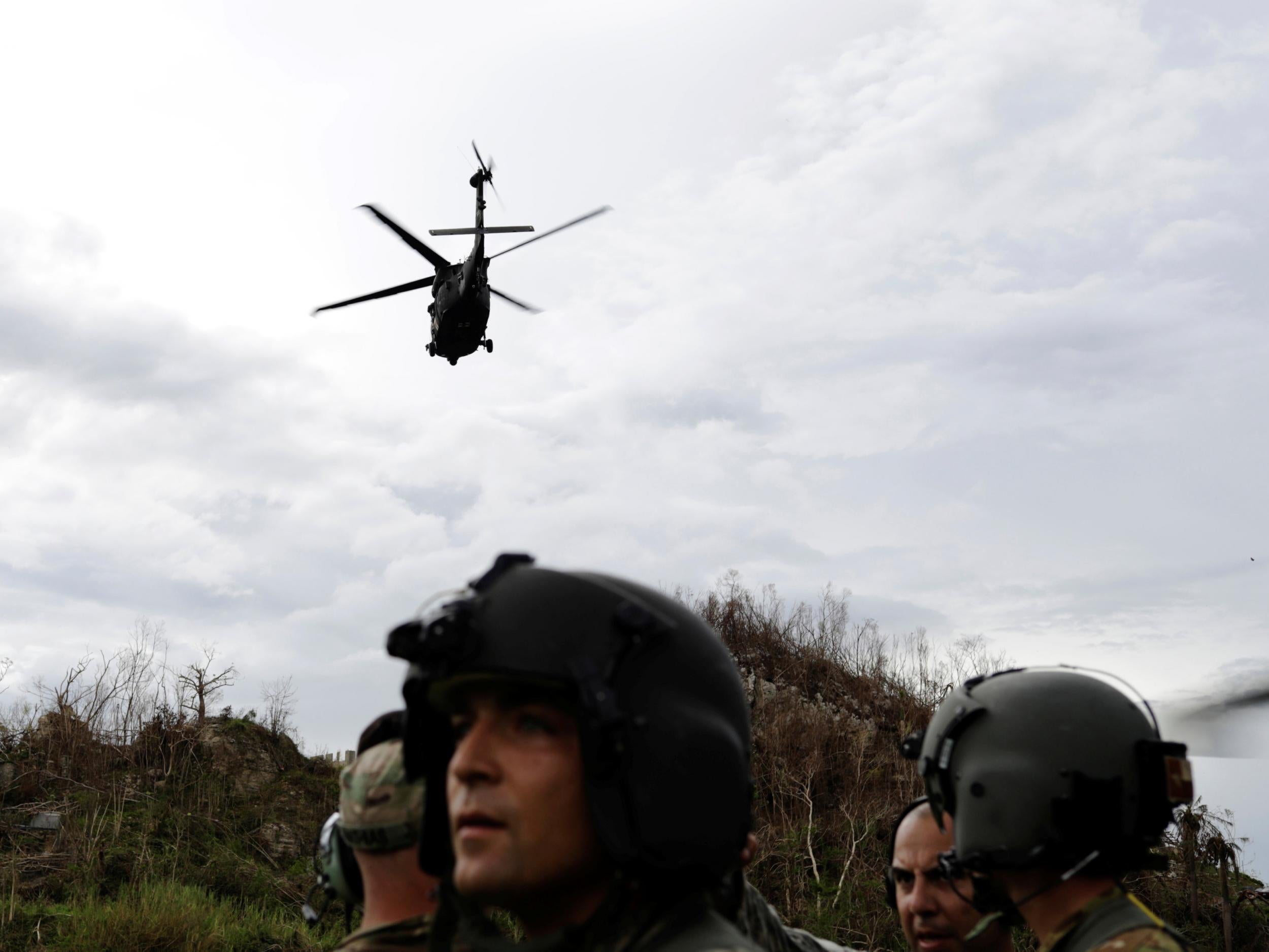 An HH-60 Blackhawk helicopter from 101st Airborne Division's "Dustoff" unit takes off behind Crew Chief Alexander Blake and his fellow soldiers during recovery efforts following Hurricane Maria, in Morovis, October 5, 2017
