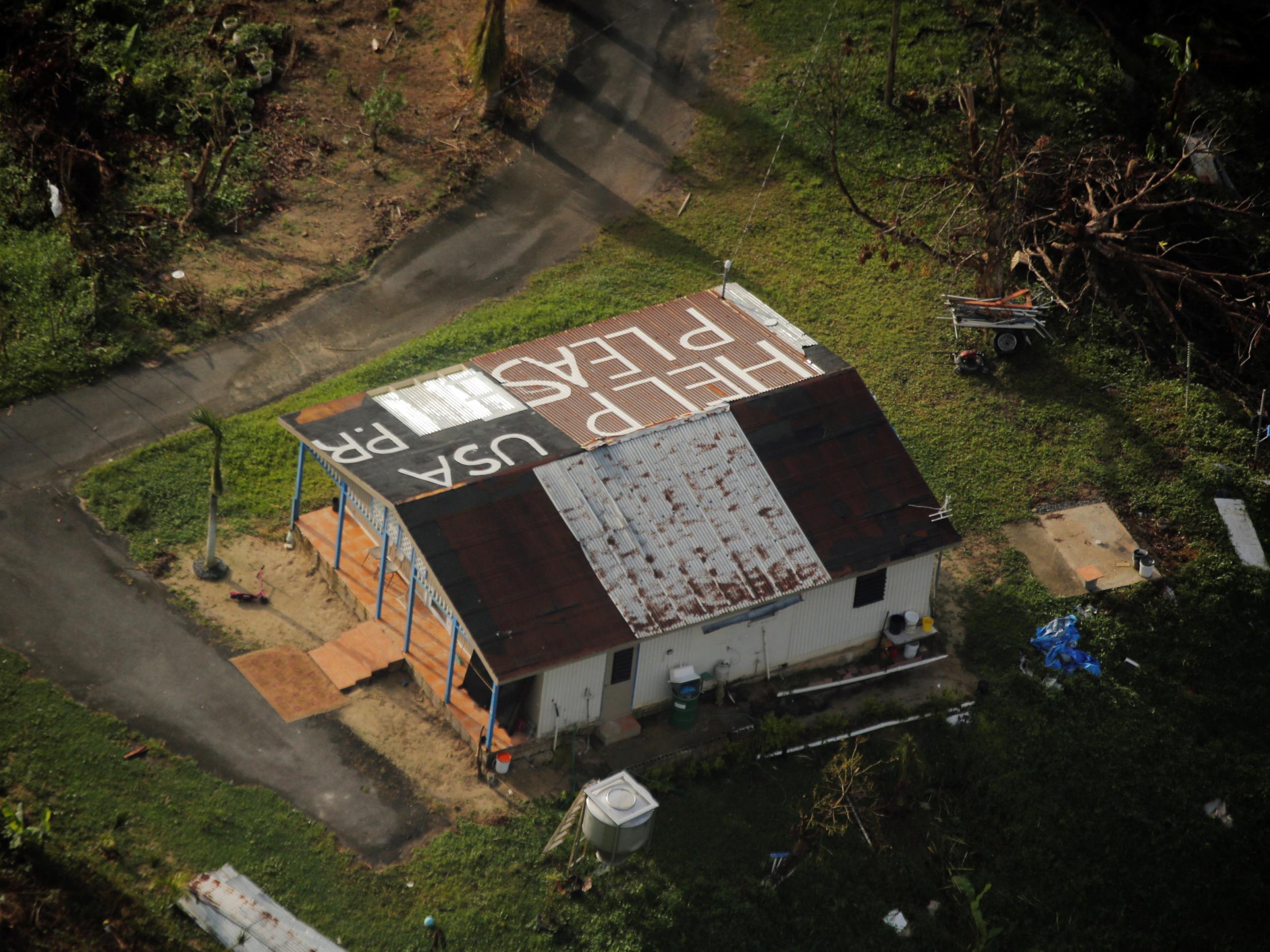 A message written on the rooftop is seen from the air during recovery efforts following Hurricane Maria near Humacao, October 10, 2017