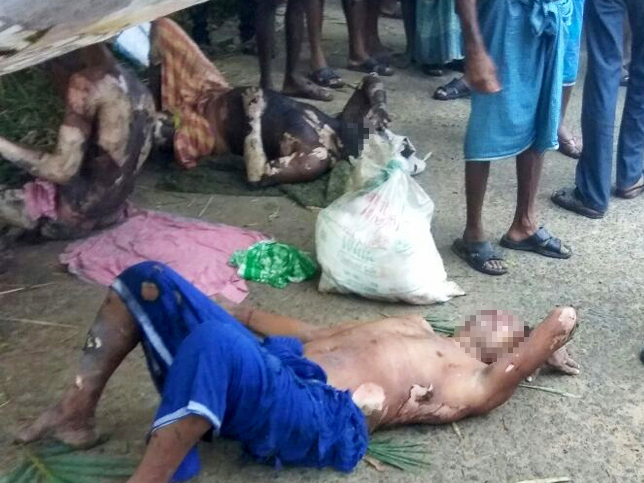 Injured people lie at the site of an explosion at an unlicensed firecracker factor