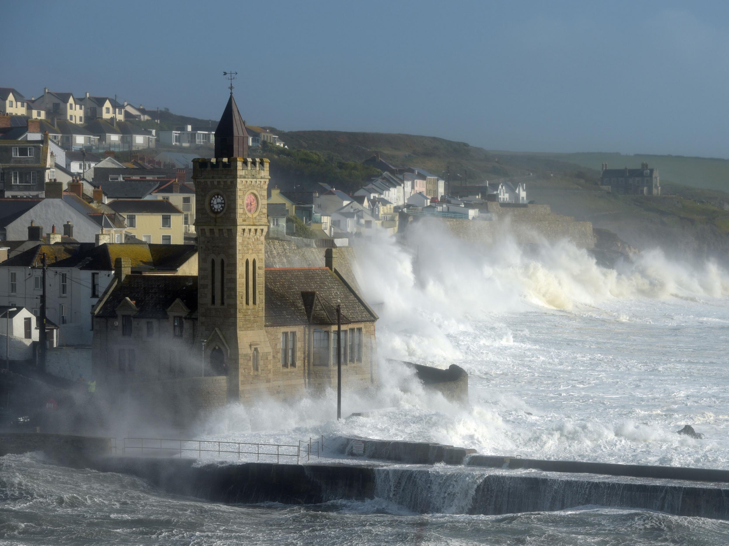 Waves break around the church in the harbour at Porthleven, Cornwall, as Hurricane Ophelia hit the UK and Ireland