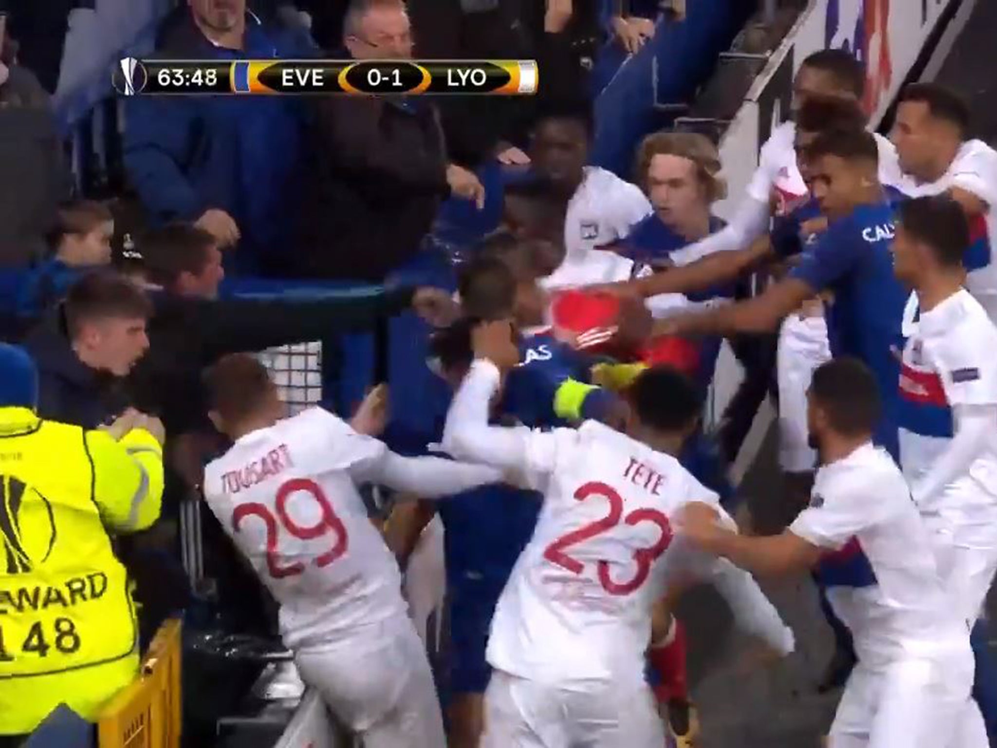 The man appears to throw a punch at Lyon player Lucas Tousart