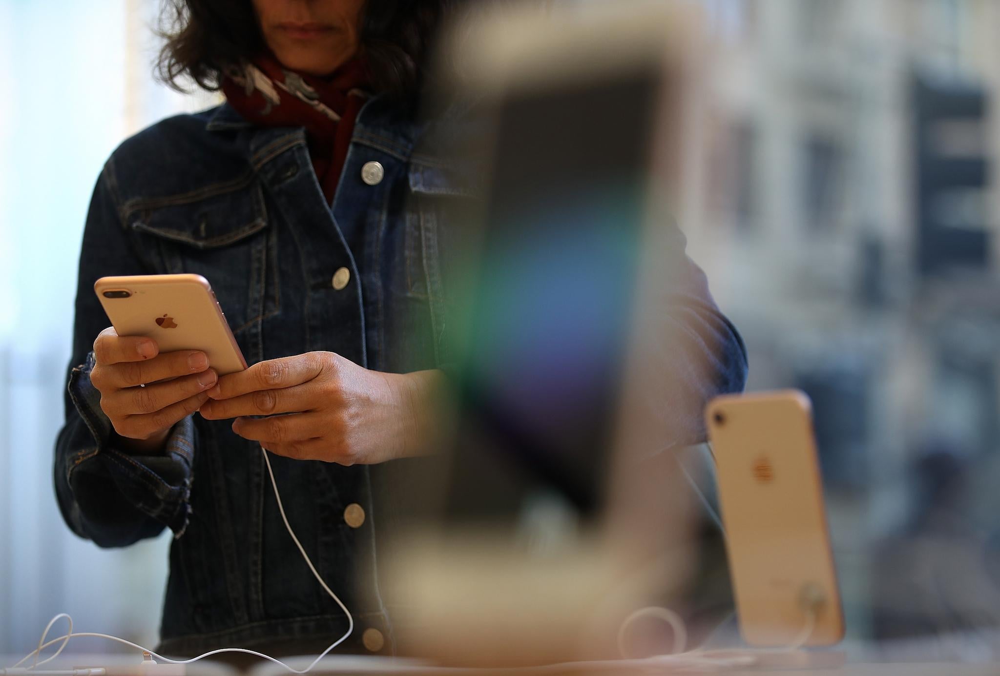 A customer inspects the new Apple iPhone 8 at an Apple Store on September 22, 2017 in San Francisco, California