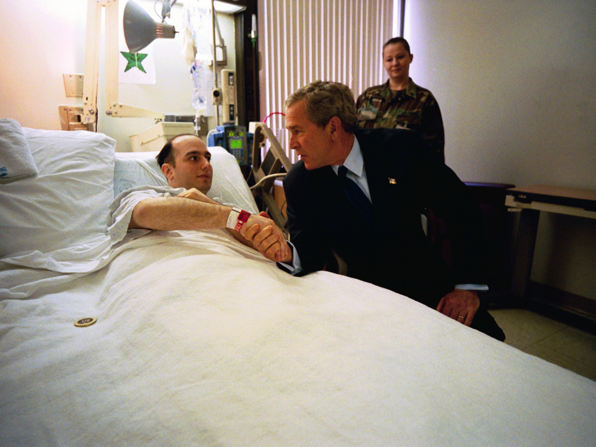 President George W. Bush shakes hands with U.S. Army Specialist Salvatore Cavallaro while visiting Walter Reed Army Medical Center