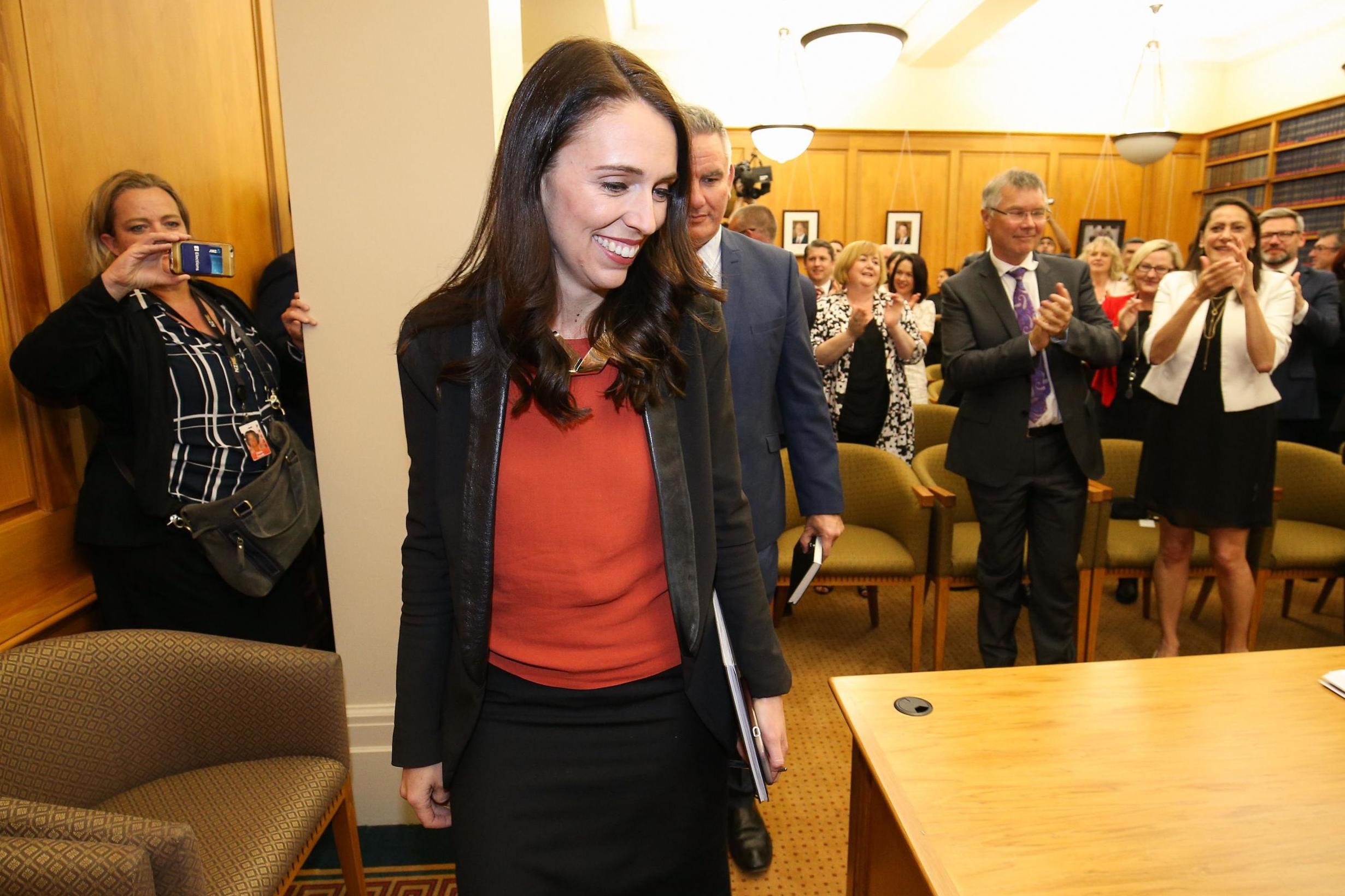 Jacinda Ardern receives a standing ovation as she arrives at Parliament after agreeing a deal to form a coalition government