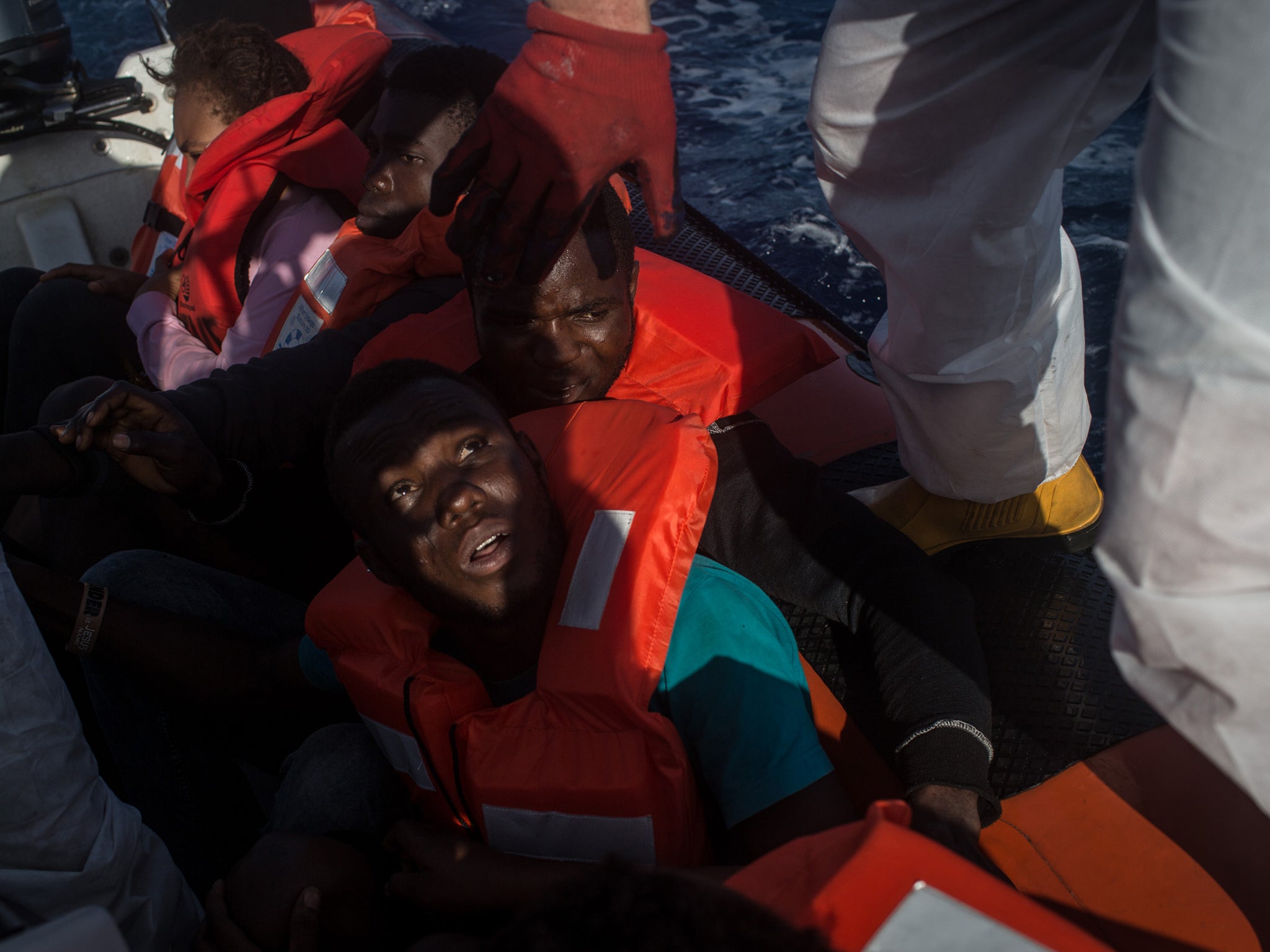 Refugees and migrants wait to be transferred from another NGO rescue ship to the migrant offshore aid station near Lampedusa, Italy on 10 June, 2017