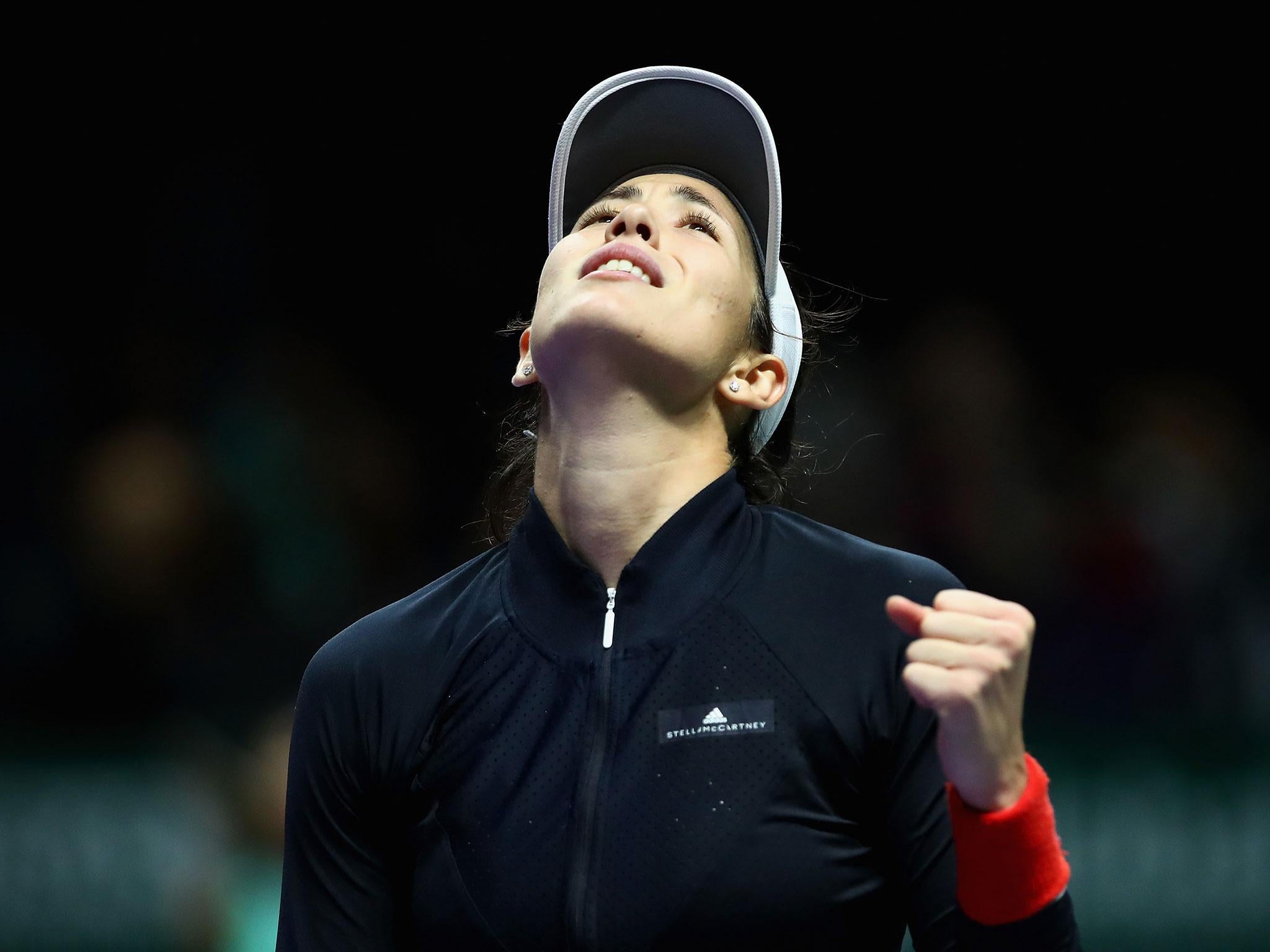 Garbine Muguruza celebrates after holding on for victory