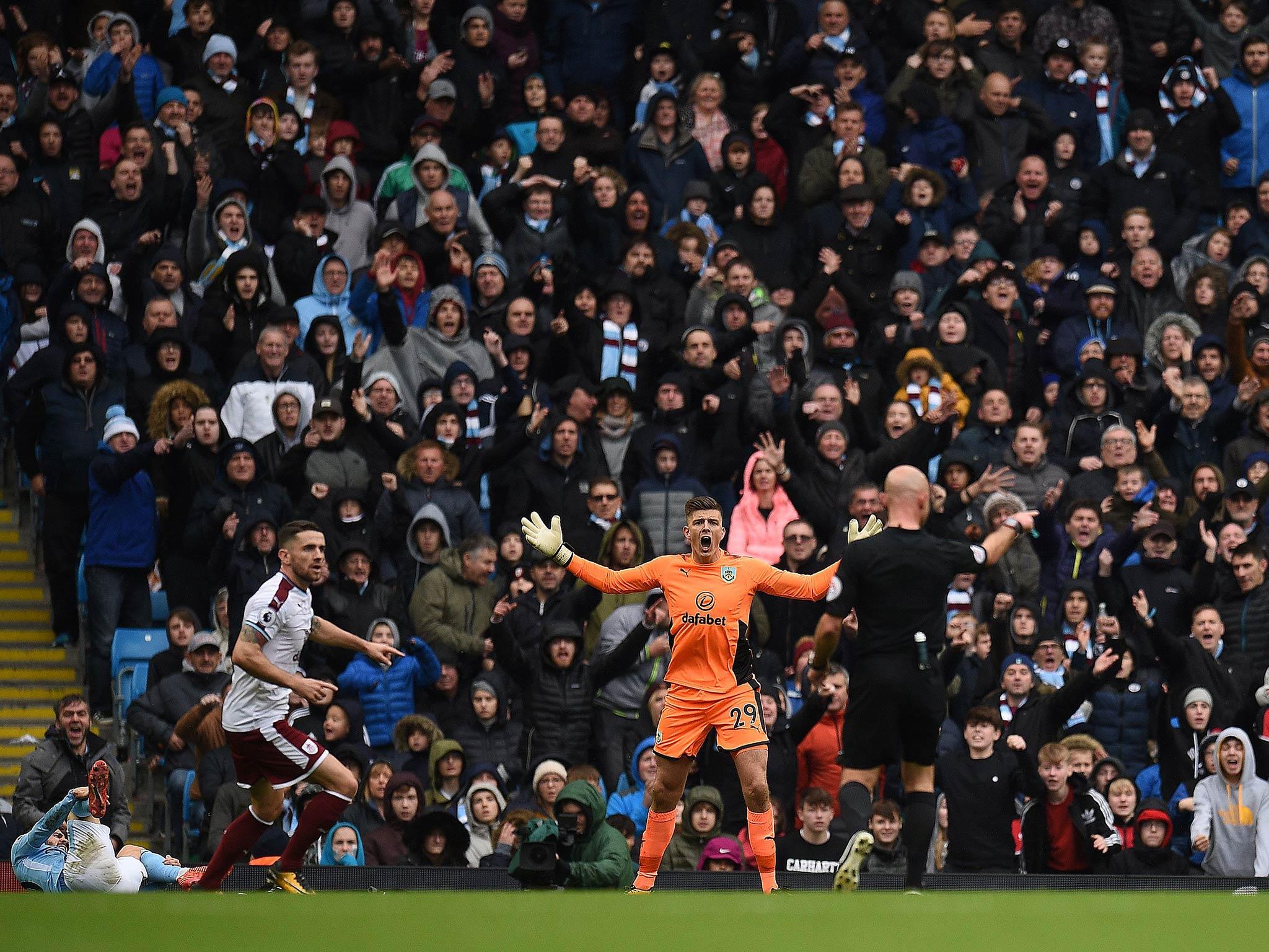 Rodger East points to the spot to Burnley's anger. Getty