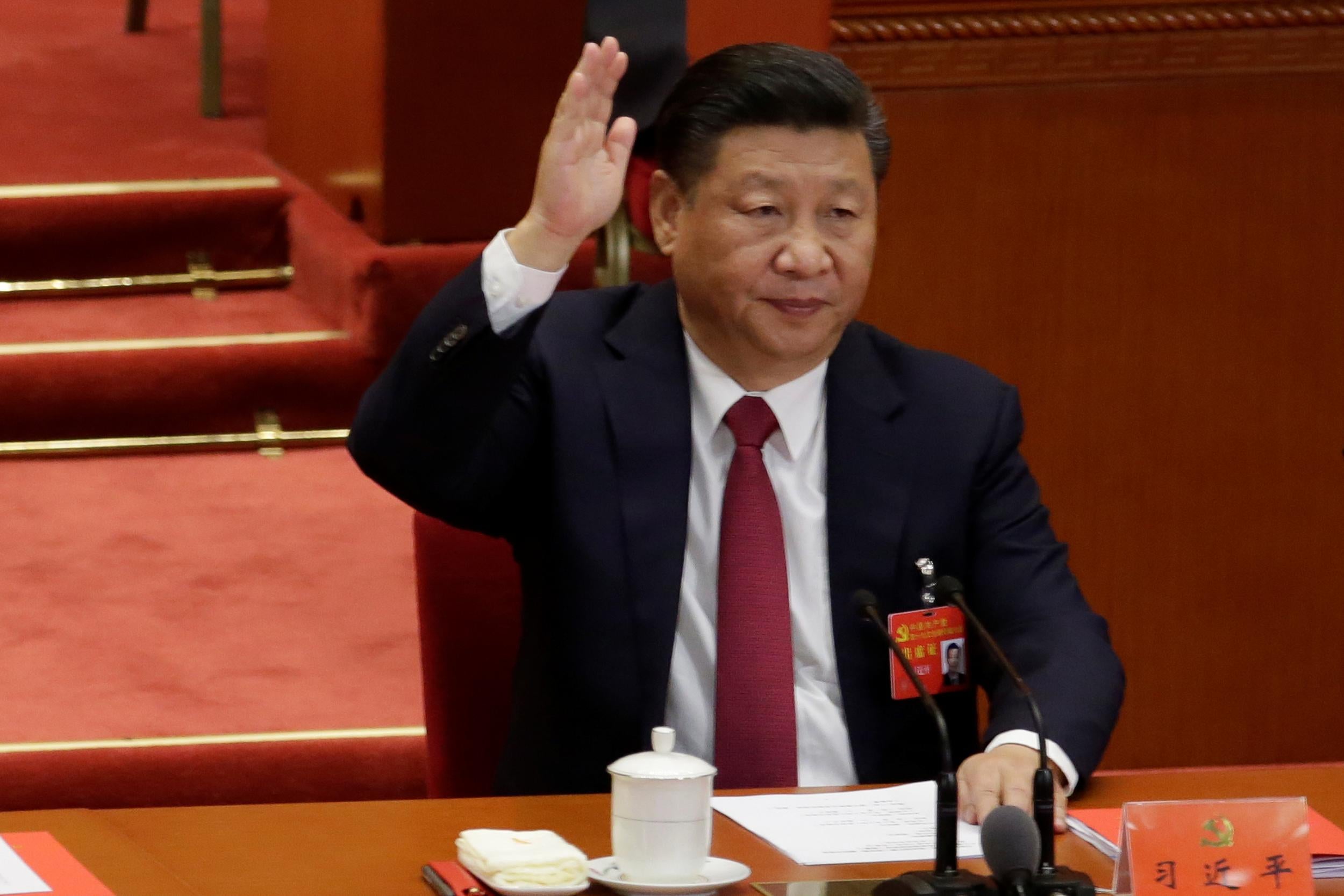 Chinese President Xi Jinping takes a vote at the closing session of the 19th National Congress of the Communist Party