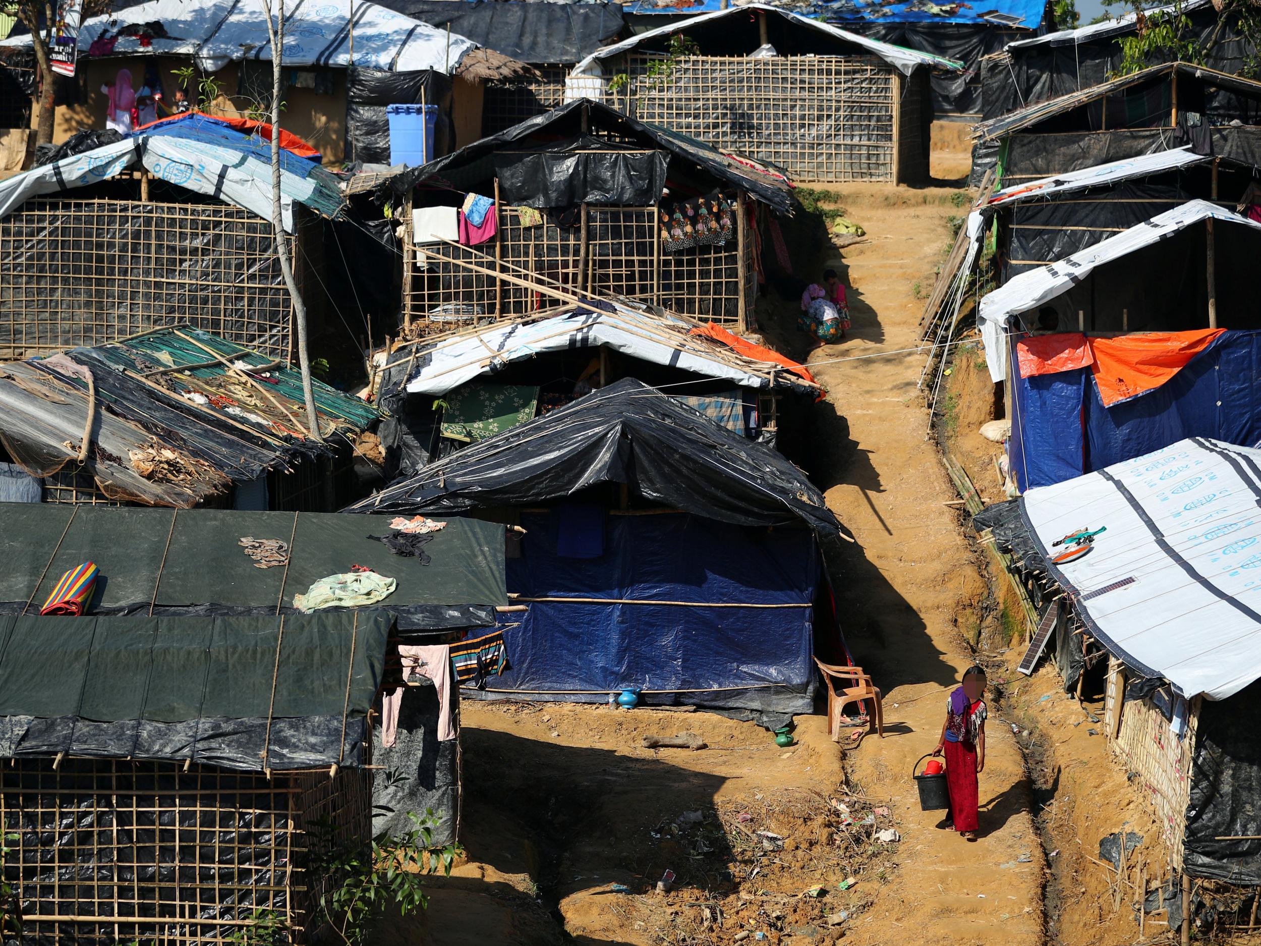 A Rohingya refugee girl walks through Kutupalong refugee camp near Cox's Bazar, Bangladesh