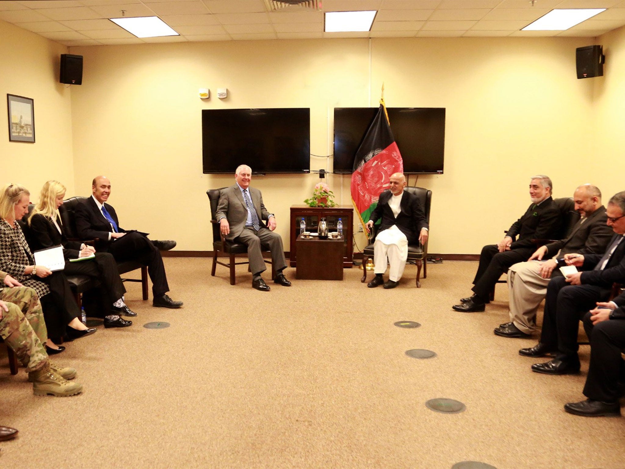 Image released by Afghan authorities of the same meeting has the clock and red fire alarm - telltale signs of a US facility - erased