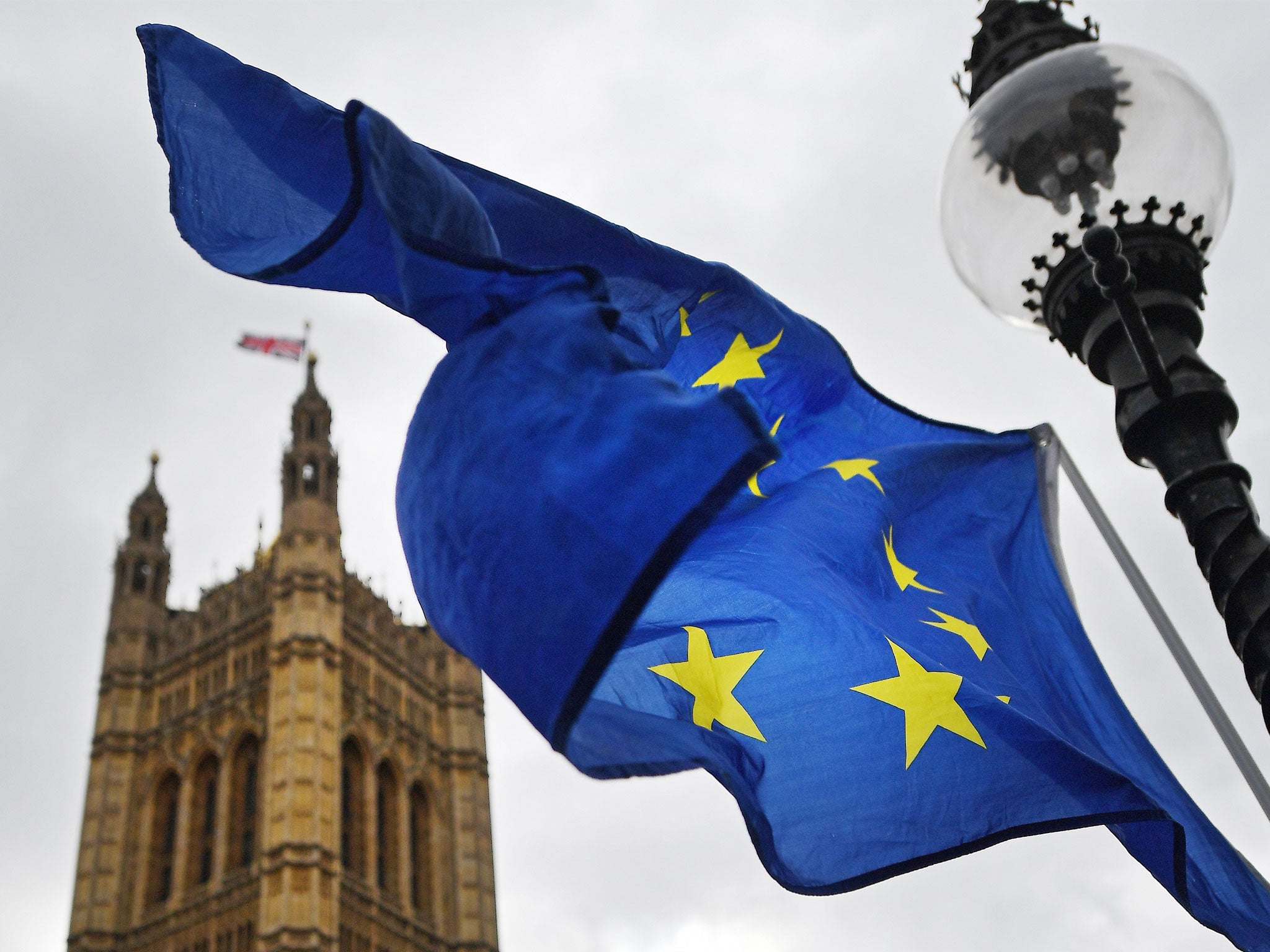 The EU flag flies outside parliament in London