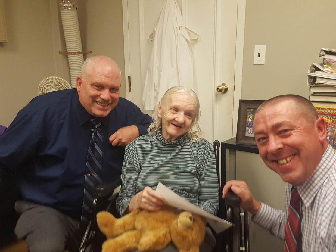 Sheriff's Detectives Ed Clouse, left, and Rich Morgan pose with Flora Stevens