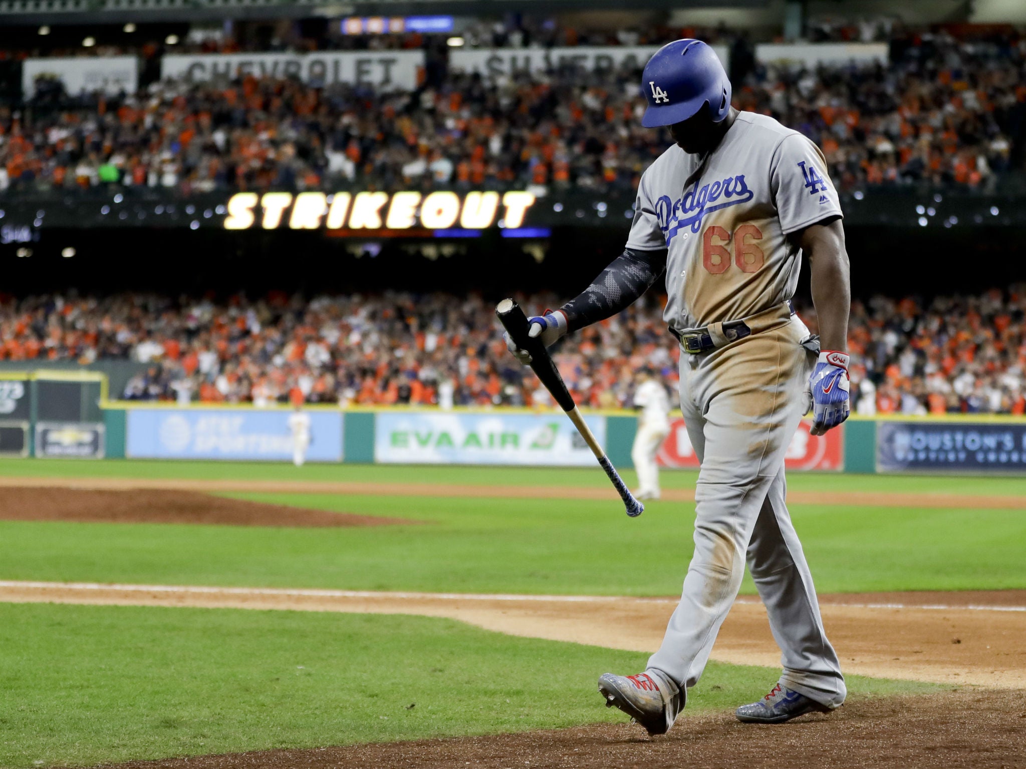 Los Angeles Dodgers' Yasiel Puig walks to the dugout after striking out in the ninth inning