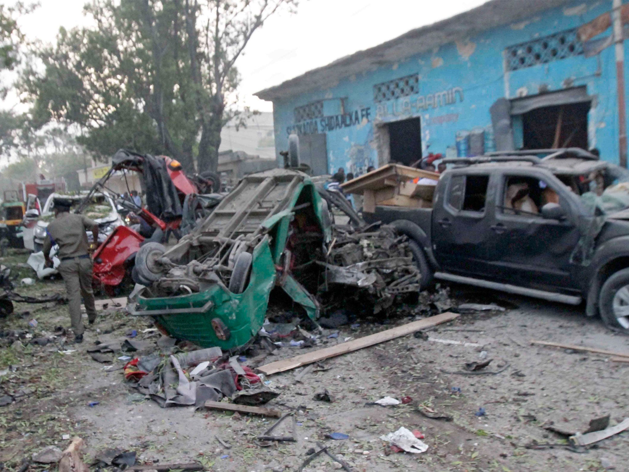 Emergency services rush at the scene of the car bomb attack in Mogadishu