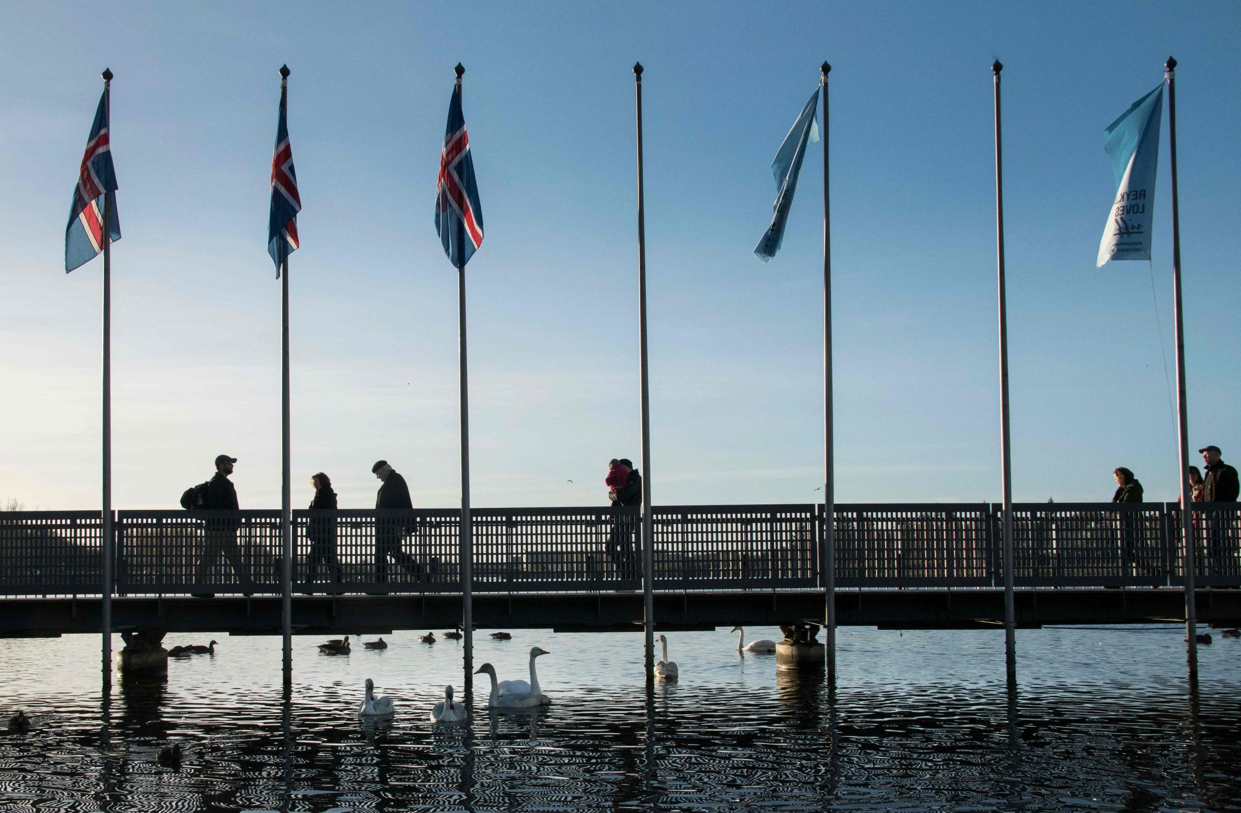 Voters go to a polling station in the city hall in Reykjavik