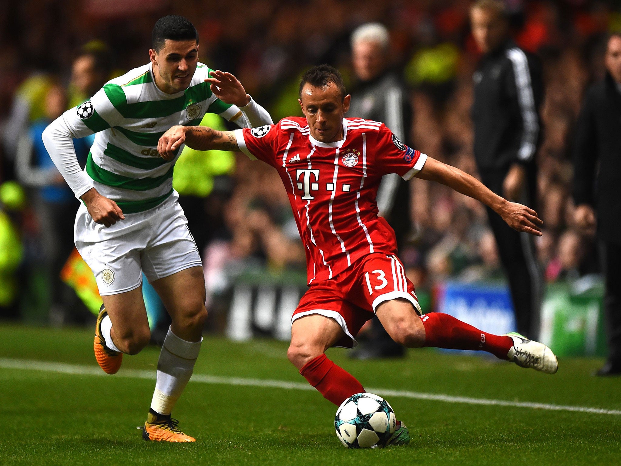 Tom Rogic vies with Bayern Munich defender Rafinha