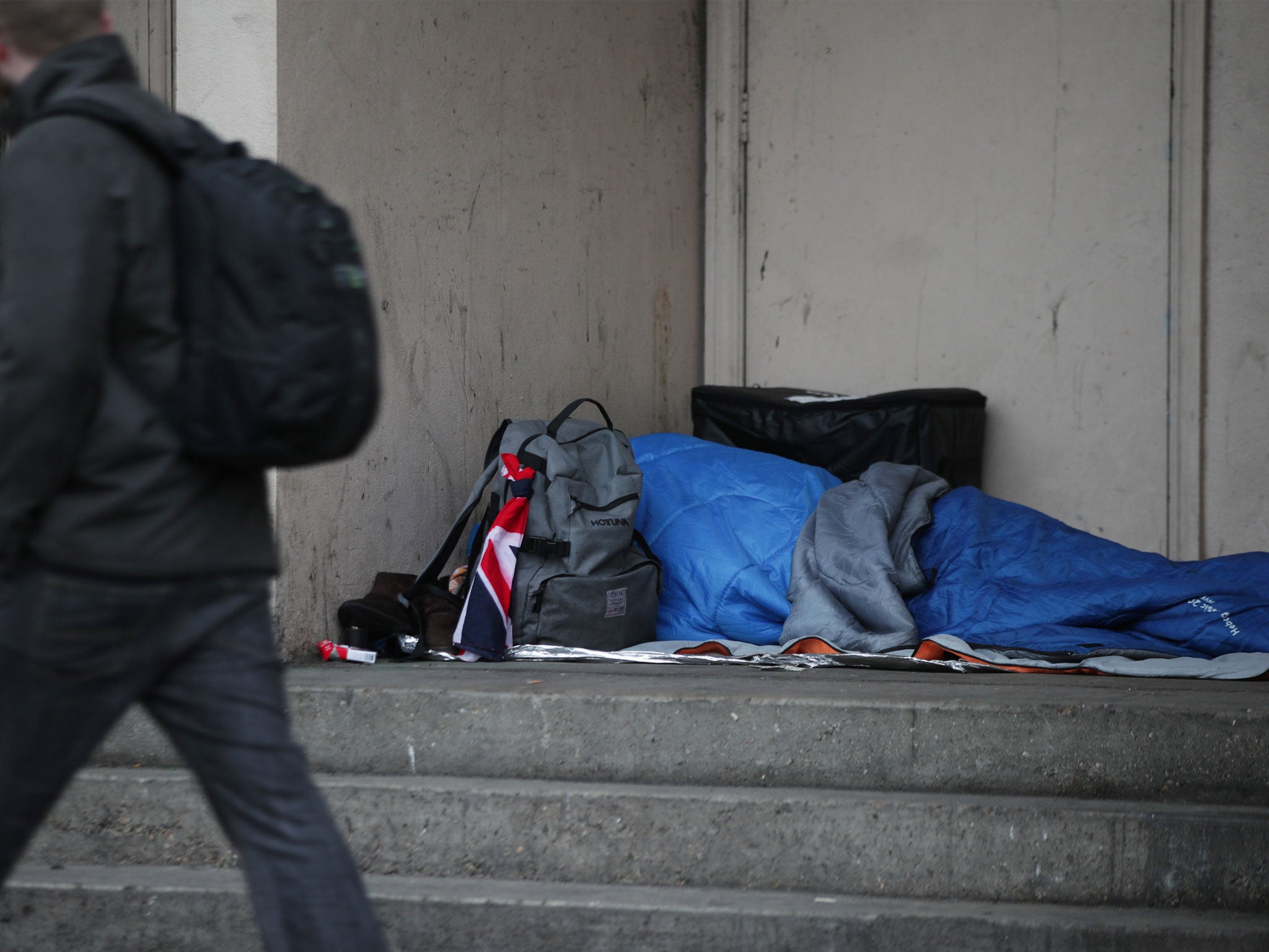 A homeless person sleeping rough in a doorway in Farringdon, London