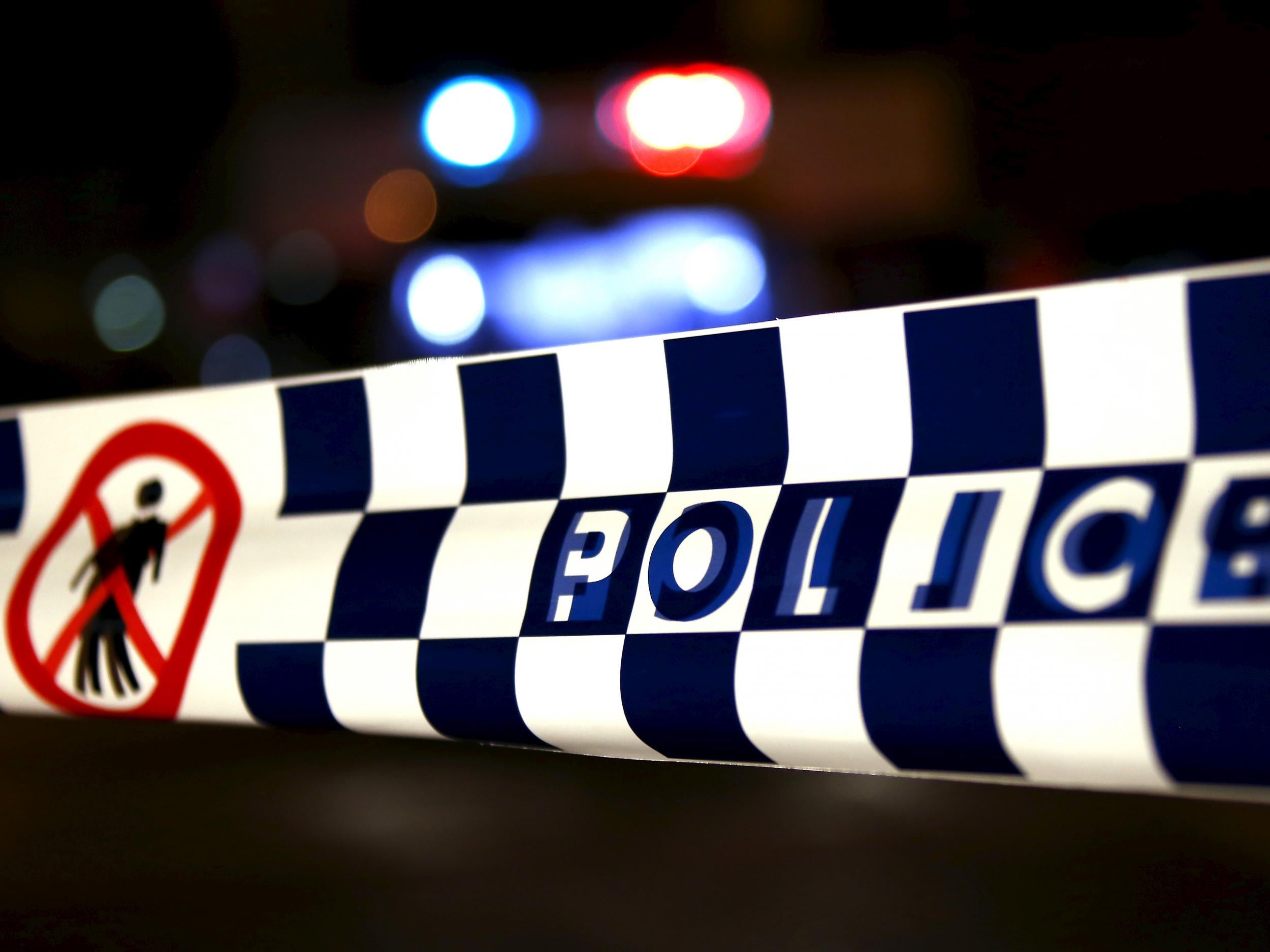 Police tape stretches across a road in Australia