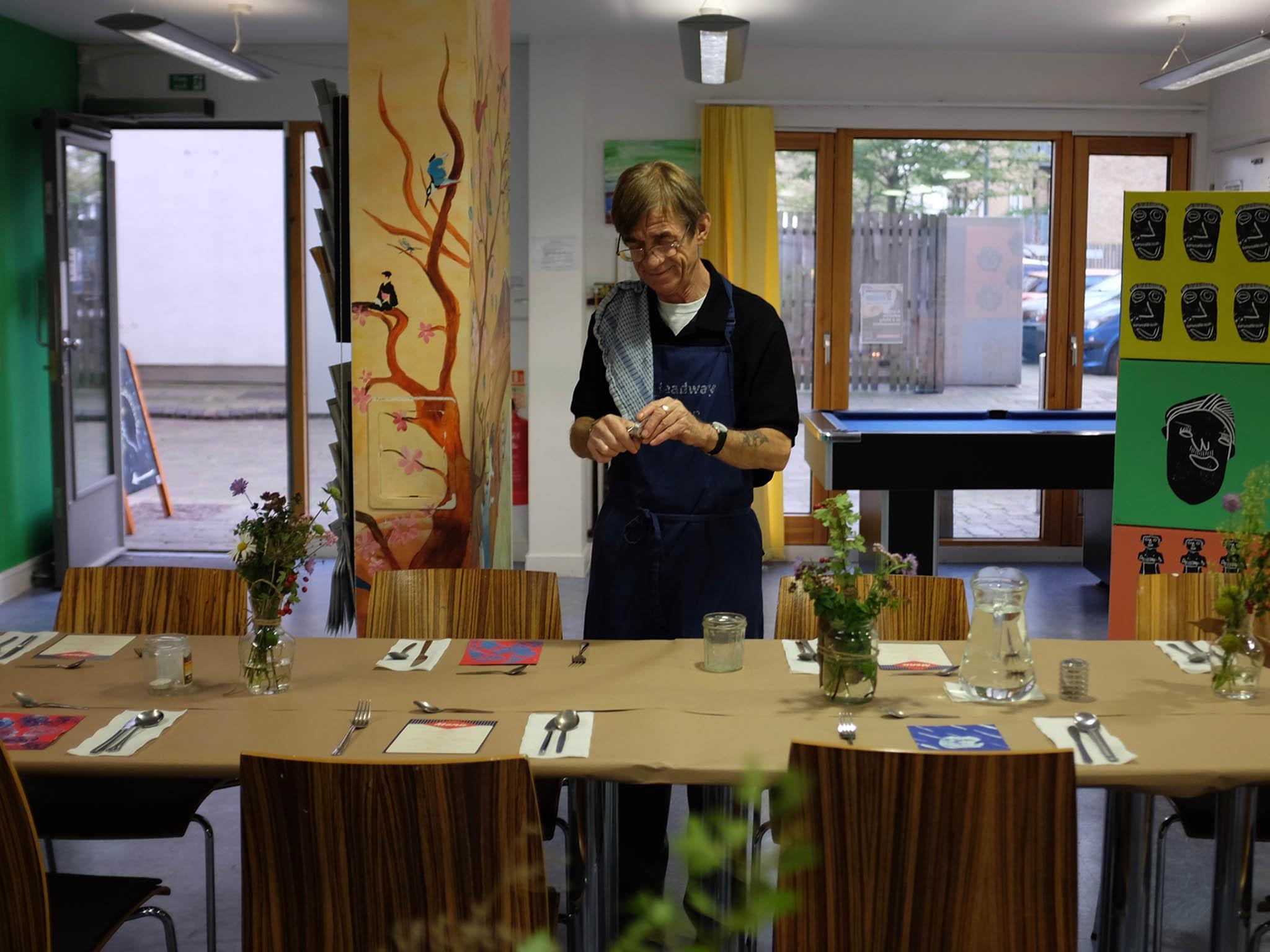 Danny, who previously worked in silver service, makes sure the table is set correctly