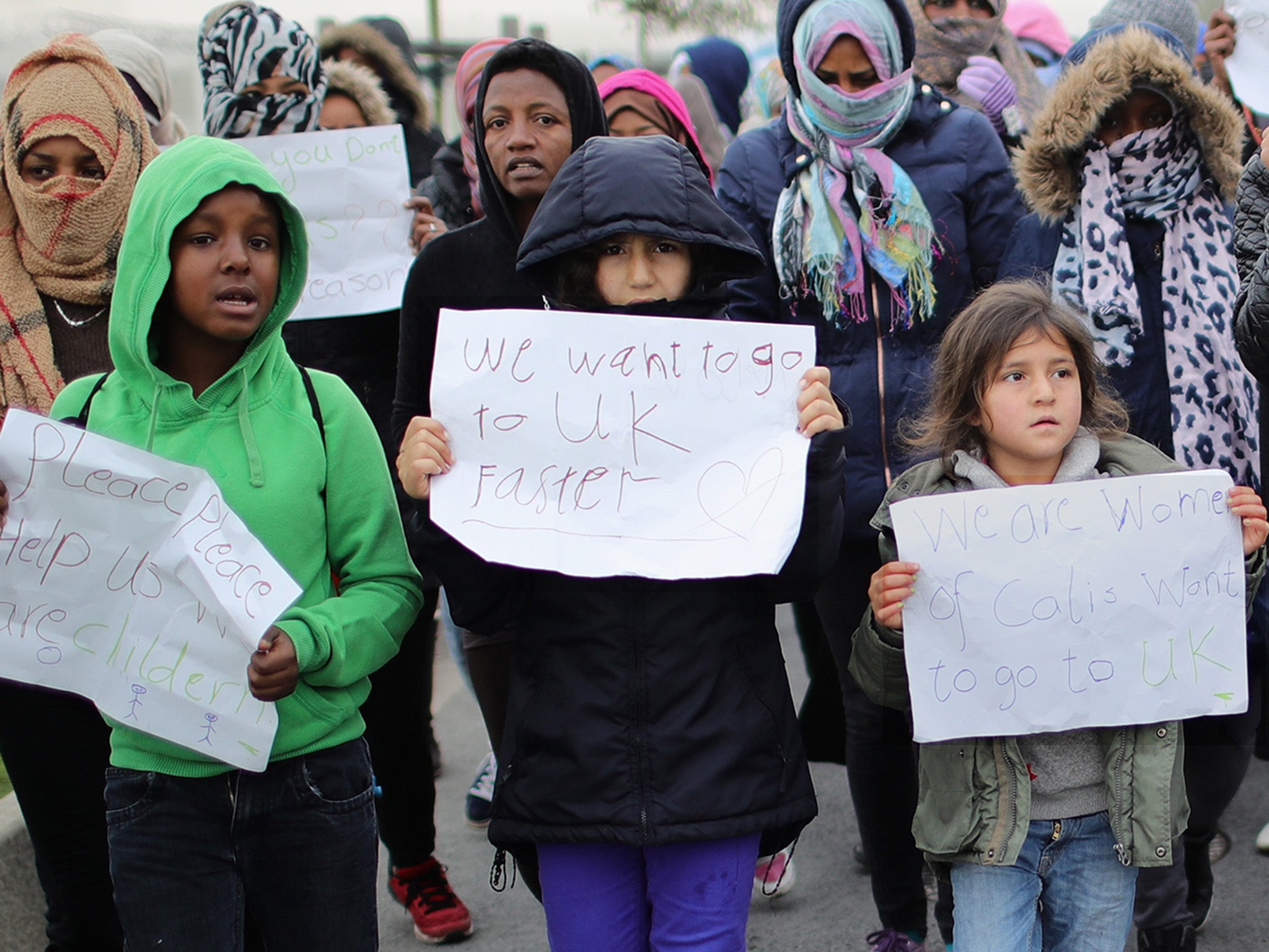 Children at the Jungle camp in 2016 urge the British Government to accept them