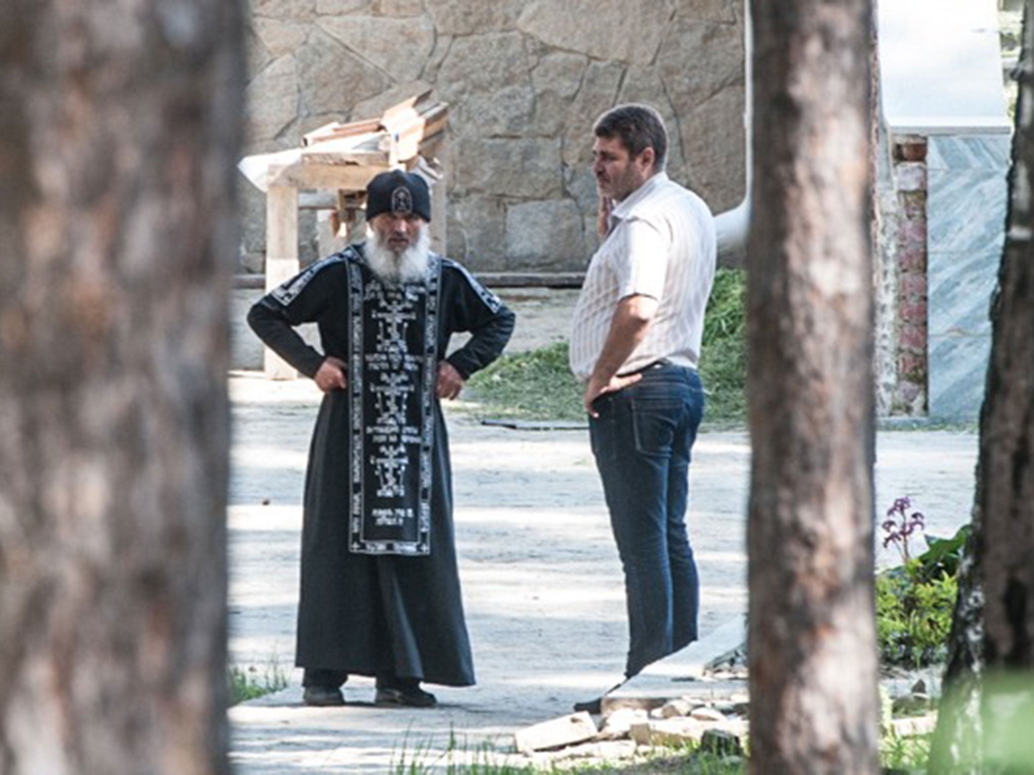 Father Sergei (left) leads a congregation of tsar worshippers. He was not available to speak to ‘The Independent’