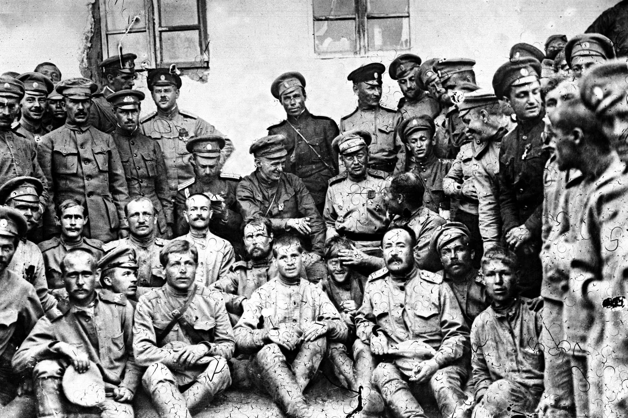 Aleksandr Kerensky seen in the centre of the group with his finger raised, joking with a Russian soldier. He was on a visit to the Russian front to encourage the troops during the First World War