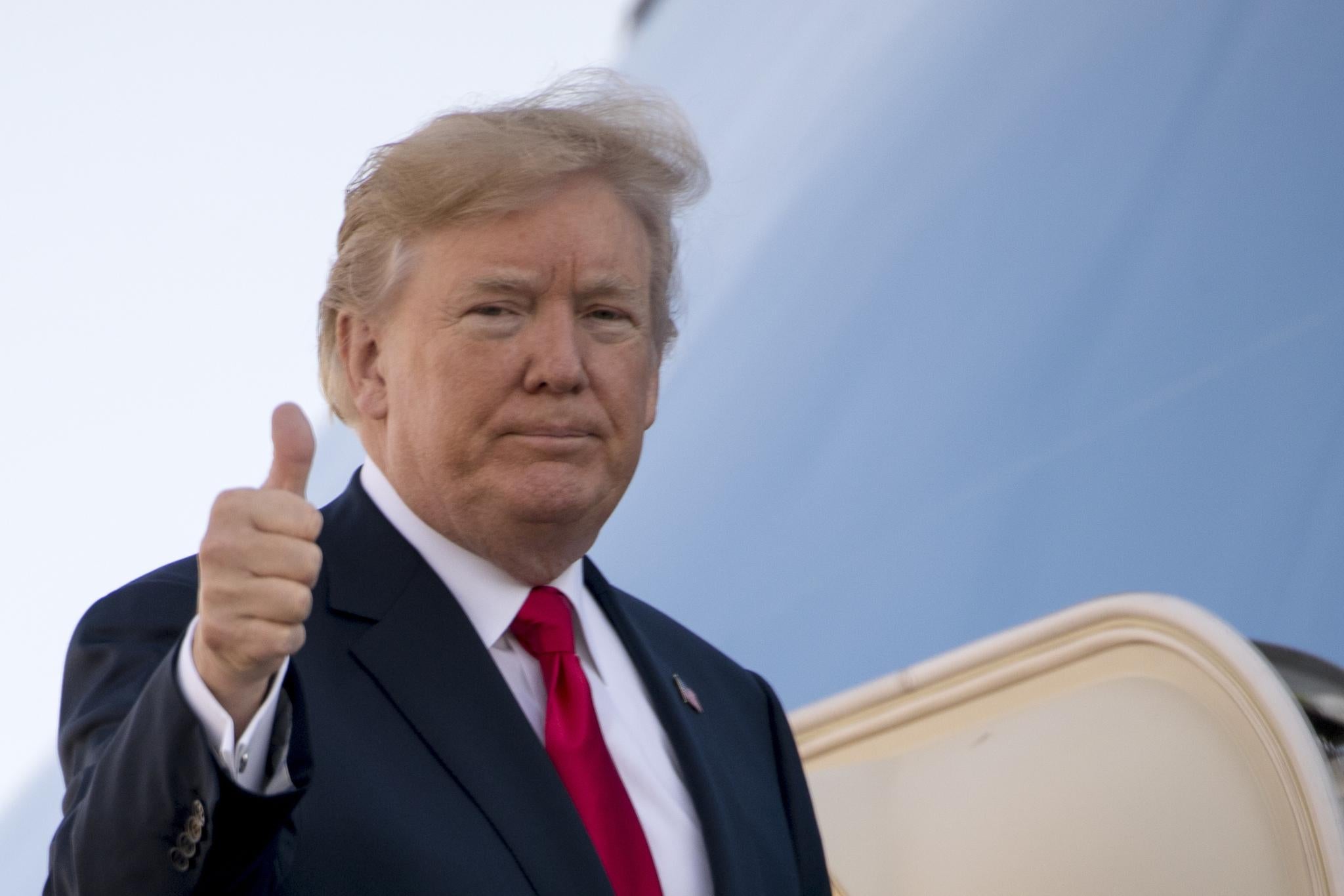 President Donald Trump gives a thumbs up as he boards Air Force One