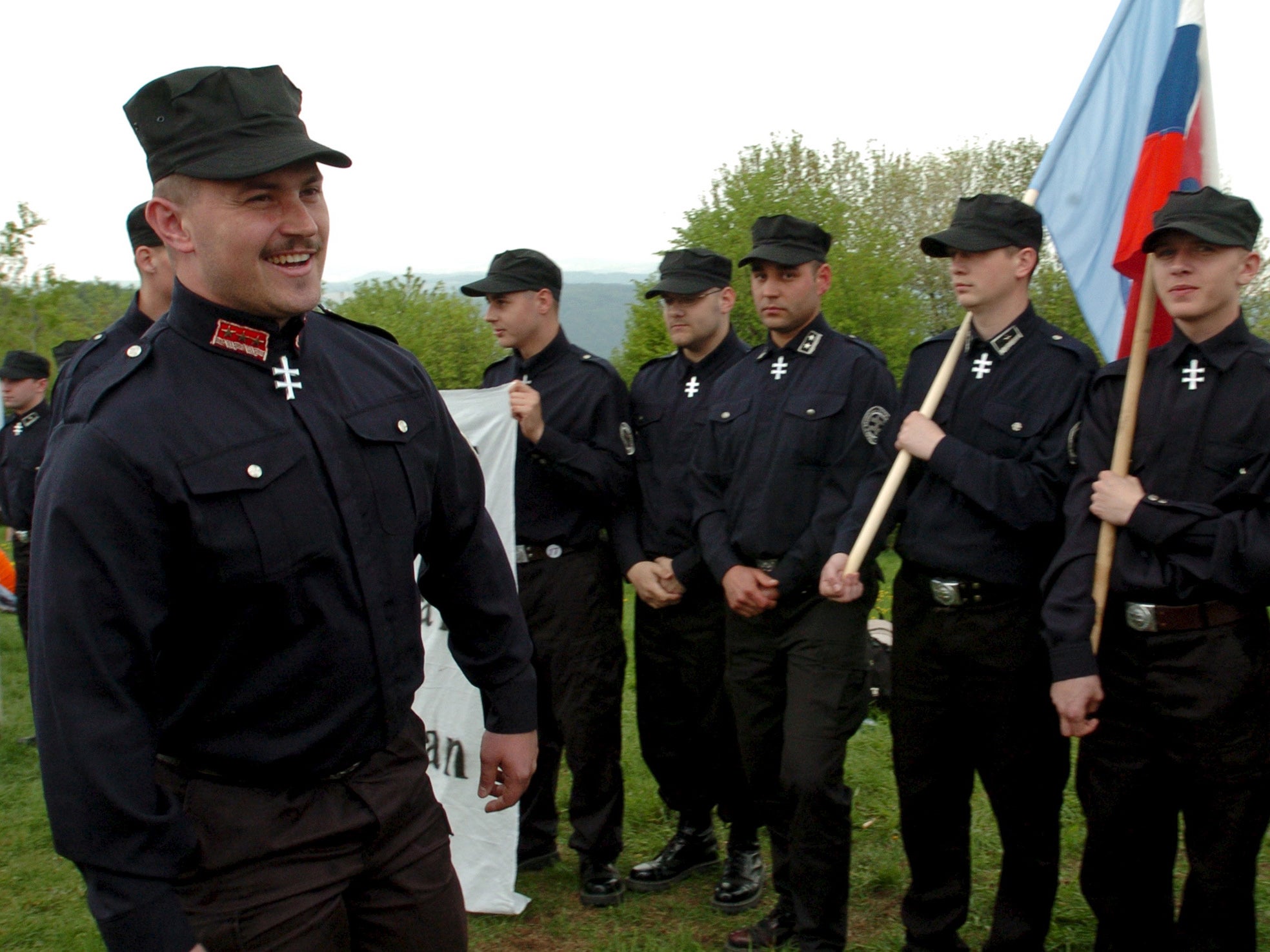 Kotleba (left) pictured at a 2006 rally dressed in far-right regalia