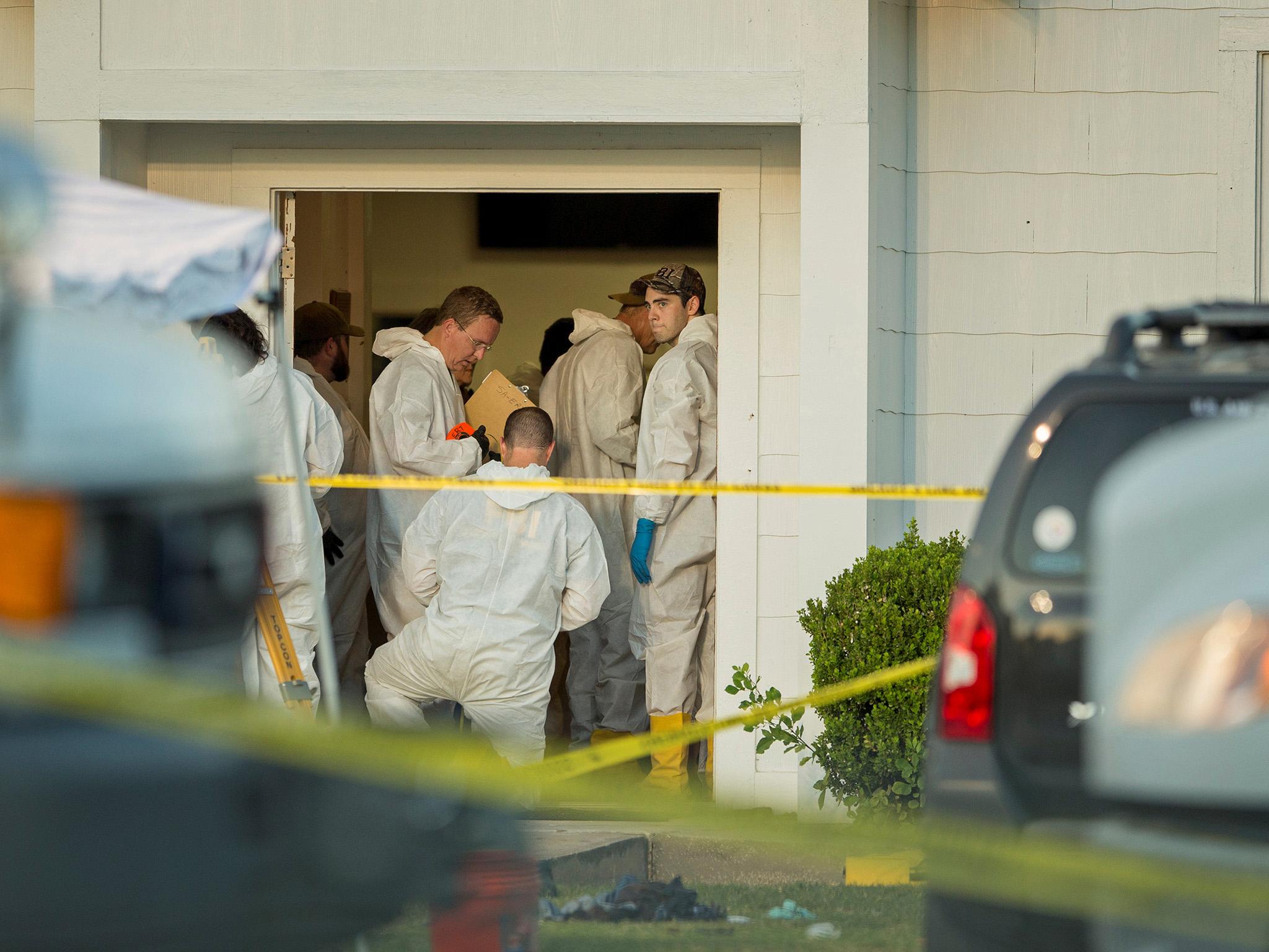 Law enforcement officials investigate the scene at the First Baptist Church in Sutherland Springs, Texas