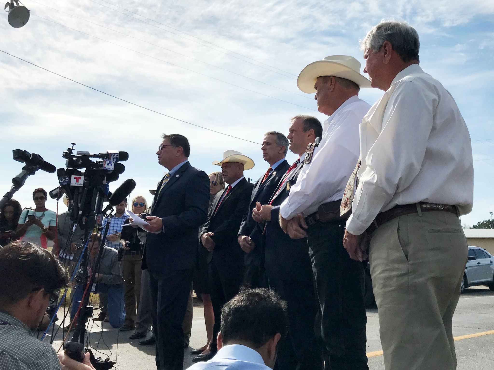 Officials speak to the news media during a news conference a day after the shooting