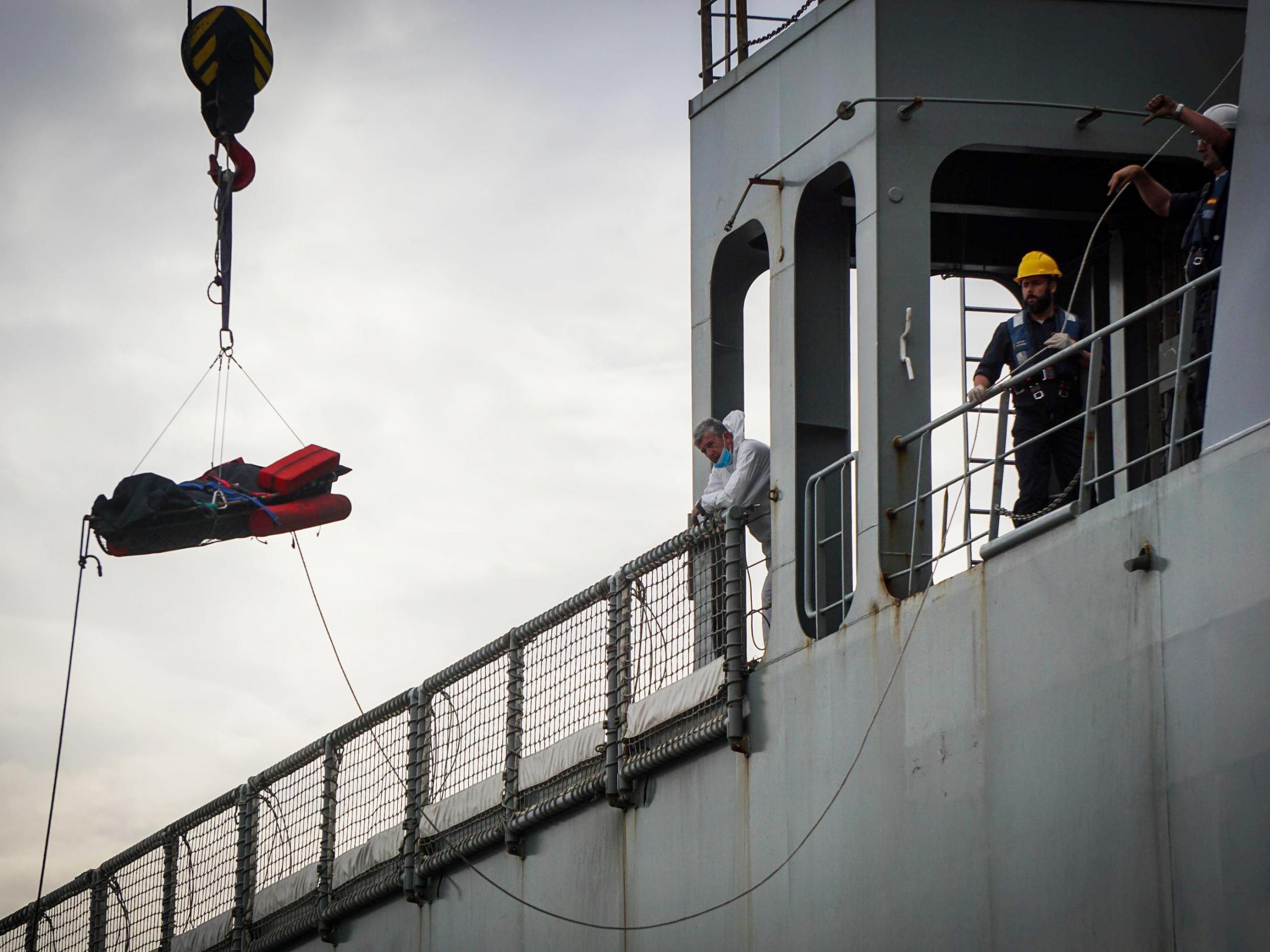 Rescuers recover a dead body from the Spanish ship 'Cantabria' in the harbour of Salerno, Italy