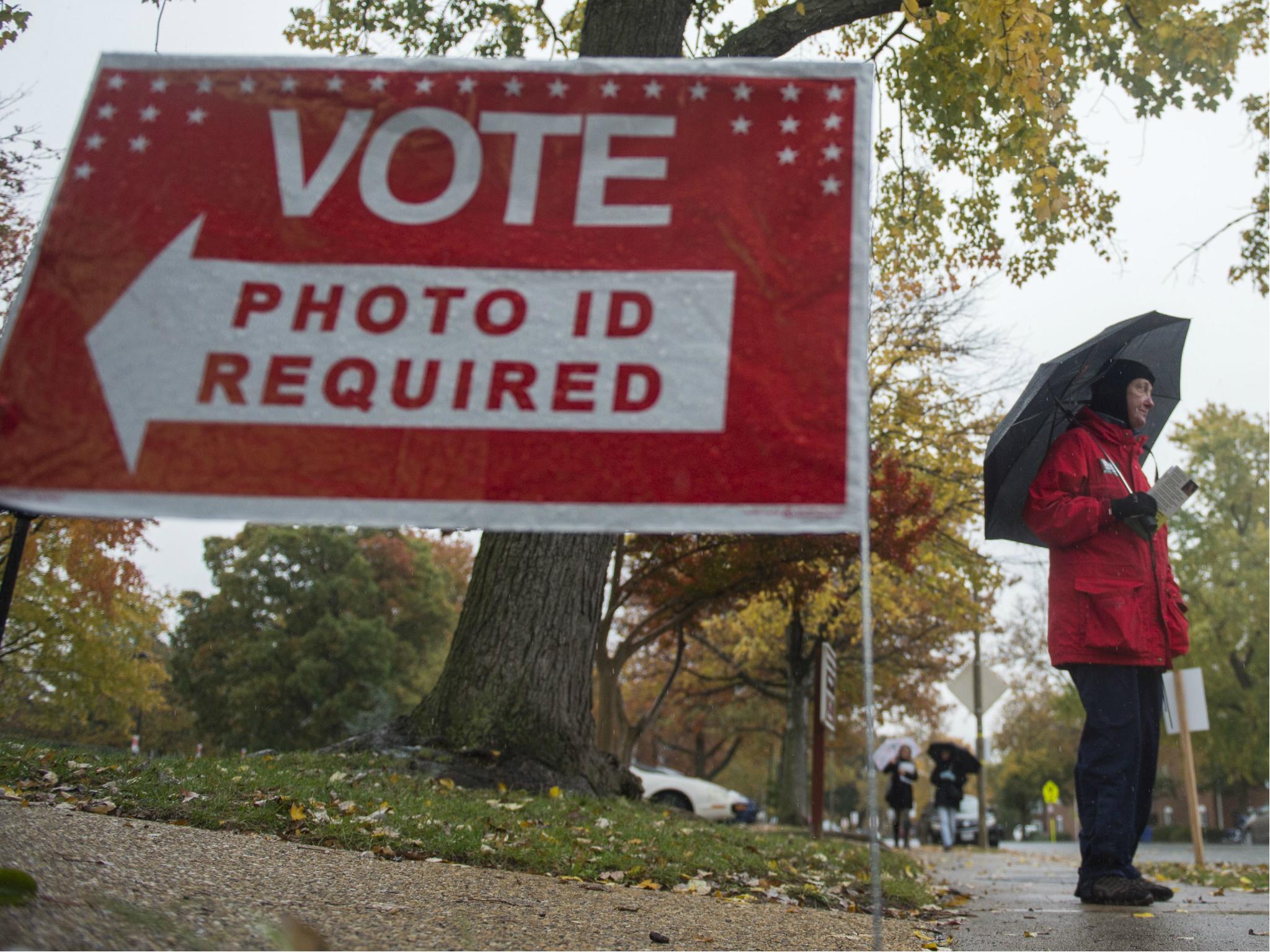 A volunteer for the Independent political party stands outside a polling station waiting to speak to voters in Arlington, Virginia on 7 November 2017.