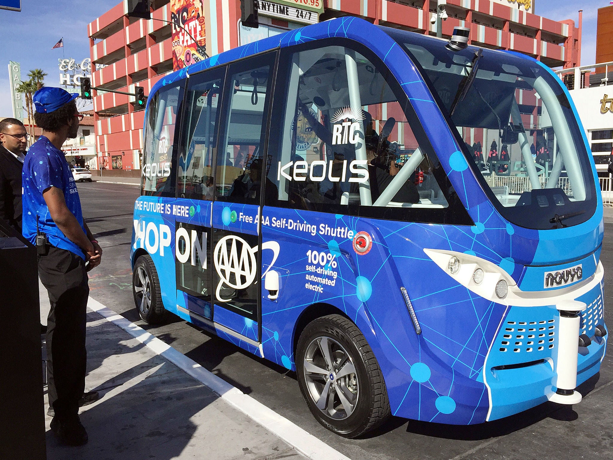 Patrons wait to board a driverless shuttle bus on a street in Las Vegas, Wednesday, Nov. 8, 2017