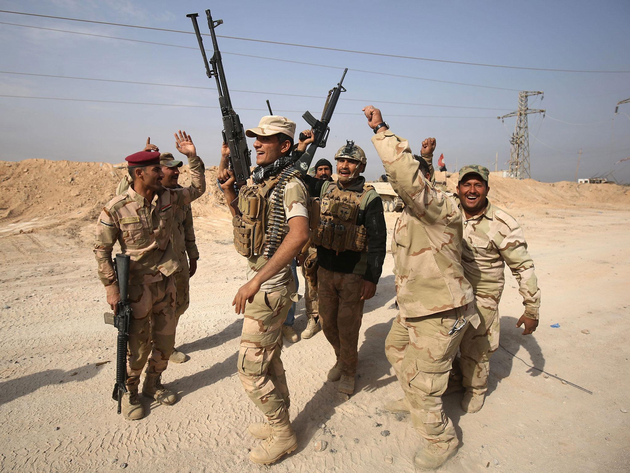 Iraqi forces celebrate near the Syrian border after recapturing a key border town