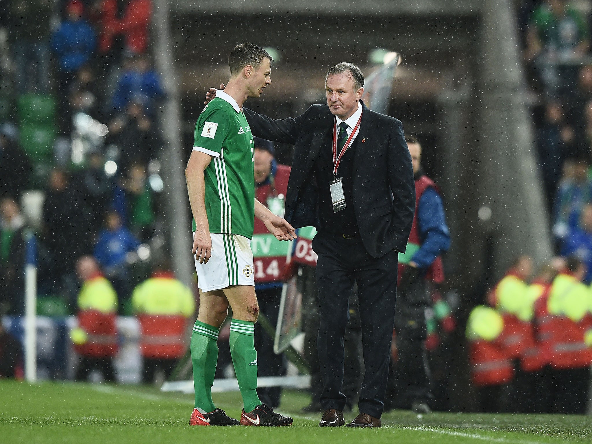 Jonny Evans speaks to manager Michael O'Neill at full-time