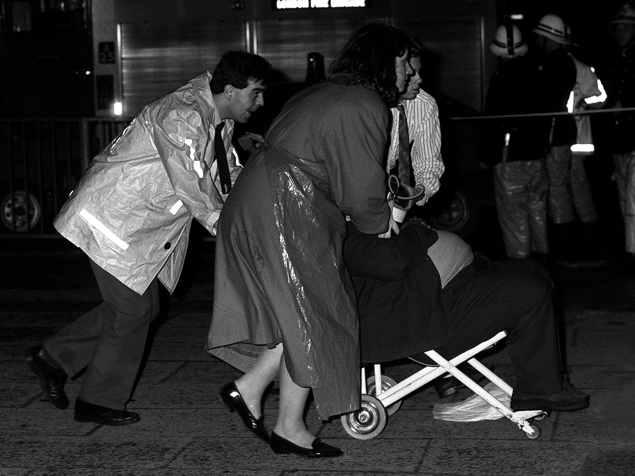 One of the injured is wheeled from the scene of the fire at King's Cross Underground station (PA)