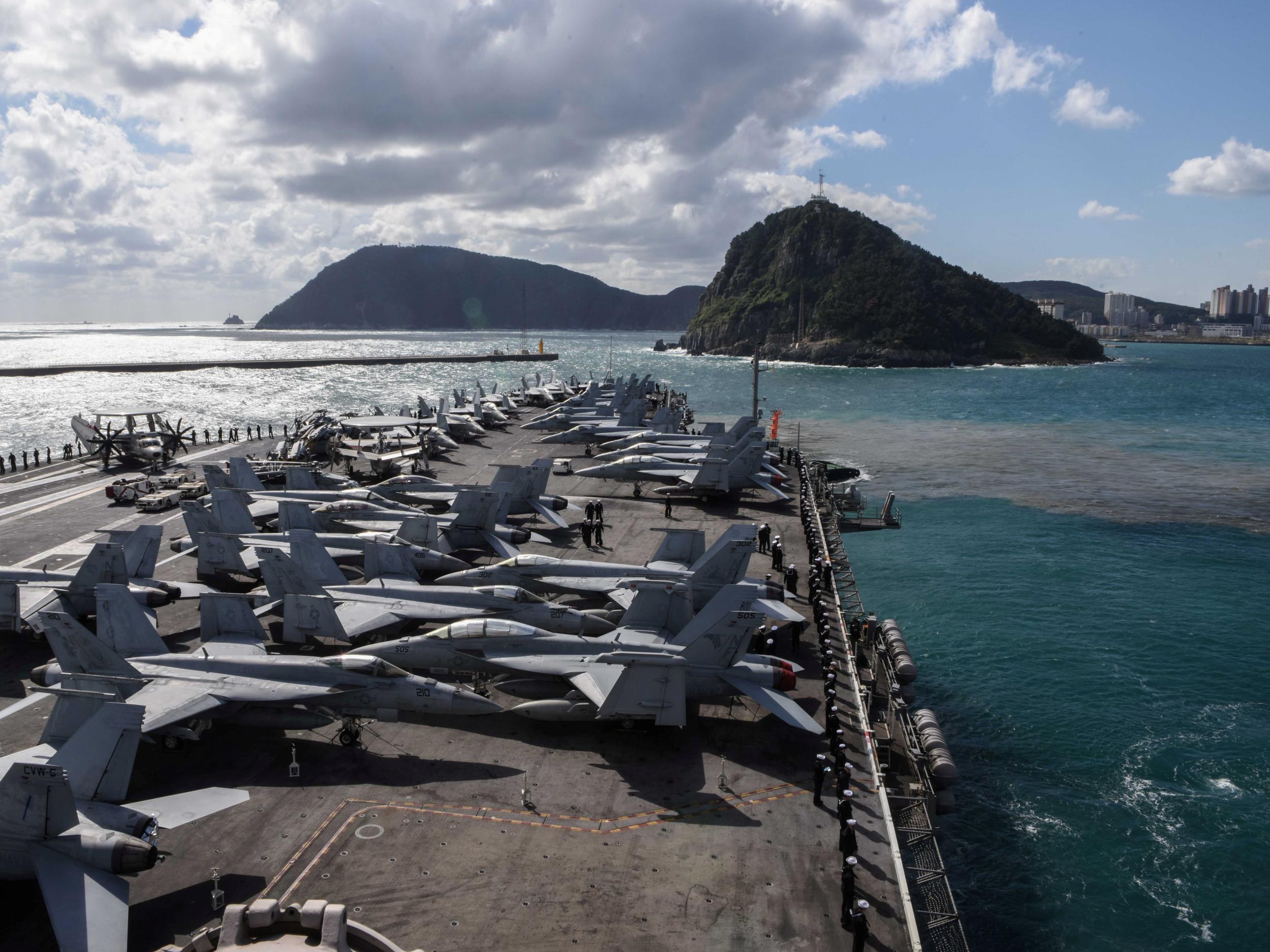 The aircraft carrier USS Ronald Reagan moves across the waters east of the Korean Peninsula prior to a scheduled port visit in Busan, South Korea