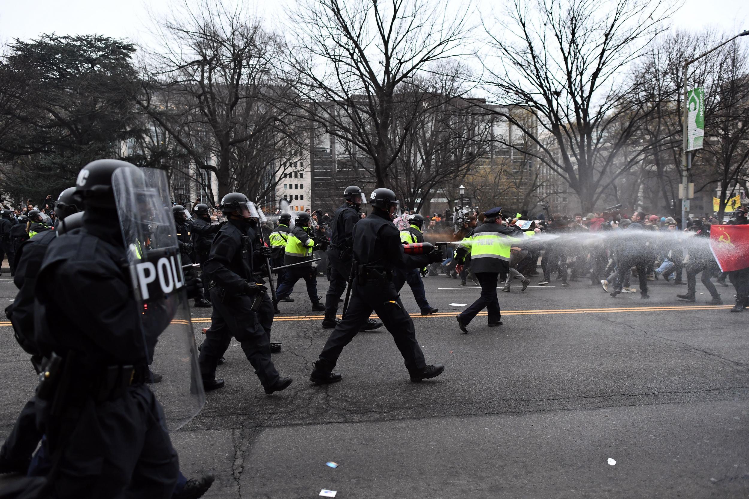 Police pepper spray at anti-Trump protesters during clashes in Washington, DC,