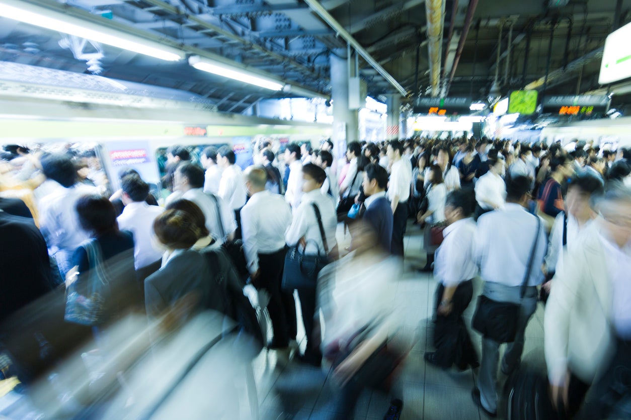 Commuters at Tokyo's Shinagawa station during rush hour