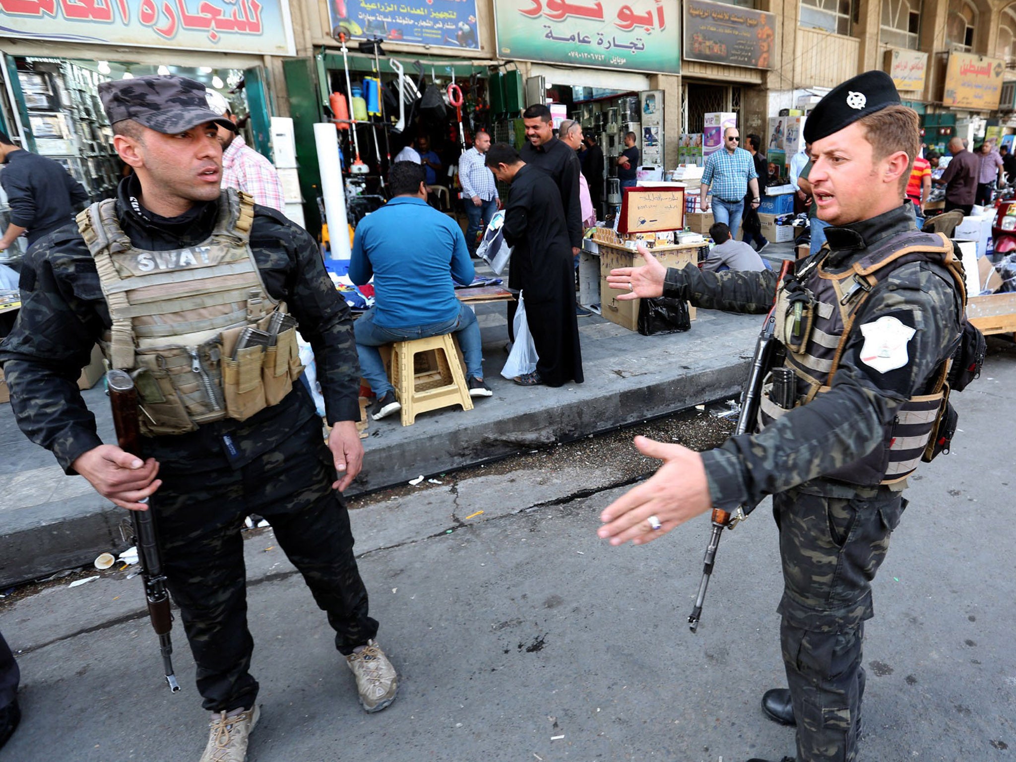 Iraqi soldiers from guard a popular market in al-Gomhouria Street in central Baghdad