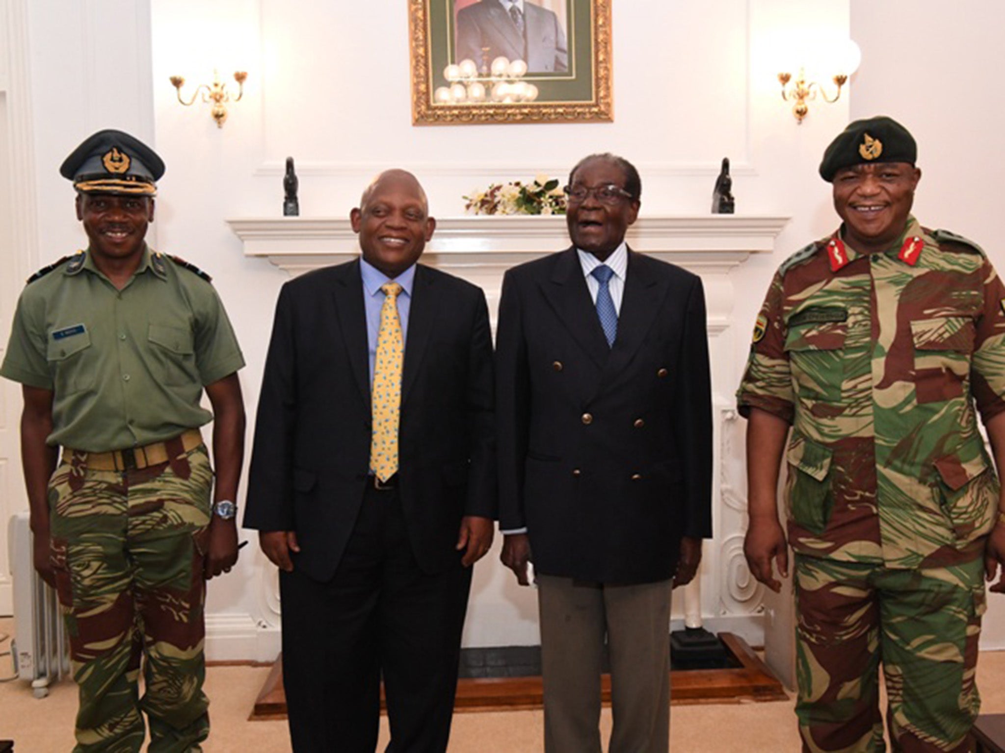 The Zimbabwean President held talks with coup leader General Constantino Chiwenga (far right) yesterday