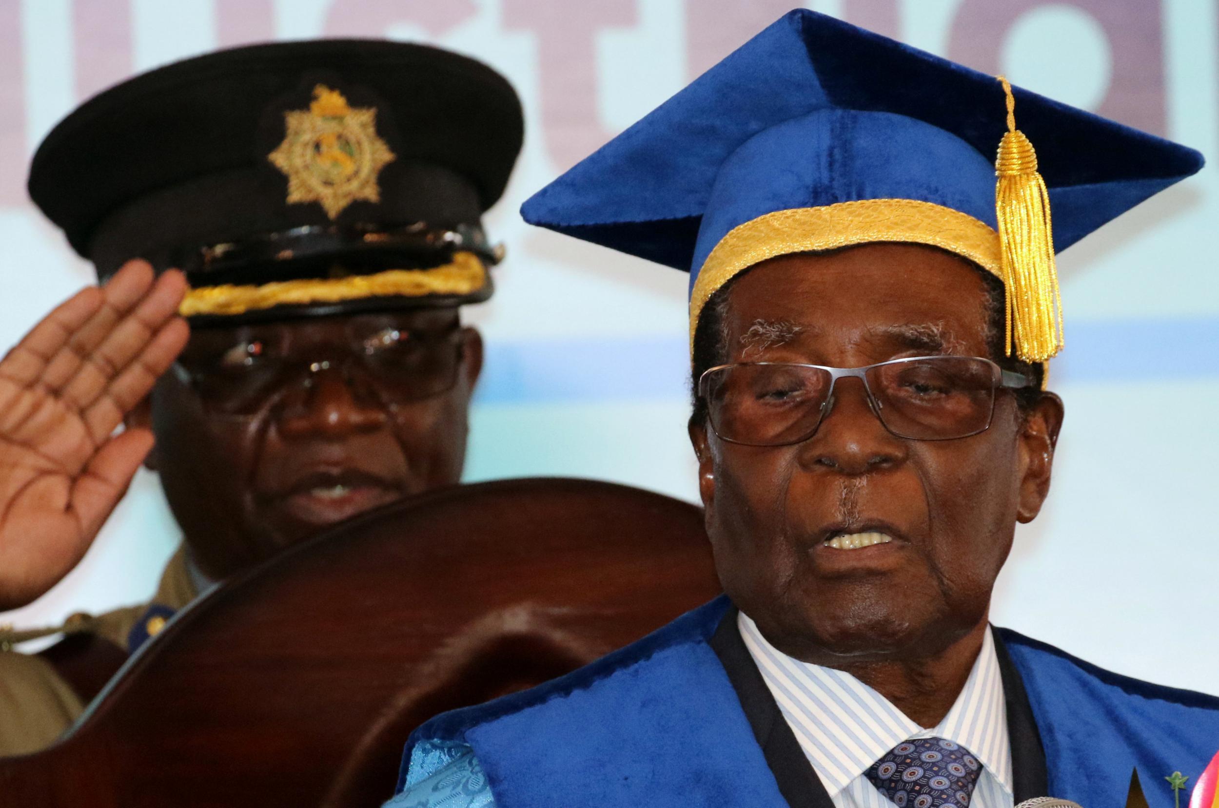 Zimbabwean President Robert Mugabe attends a university graduation ceremony in Harare in his first public appearance since the military takeover