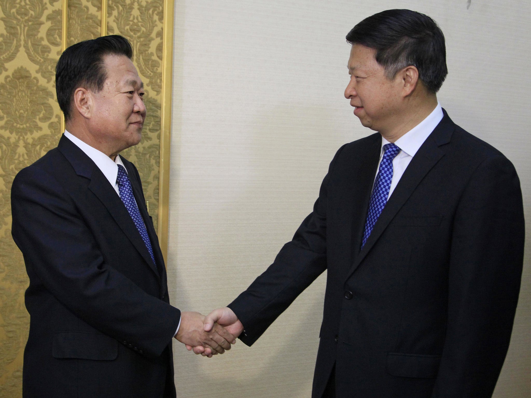 Song Tao (right) met with Choe Ryong Hae when he arrived in Pyongyang