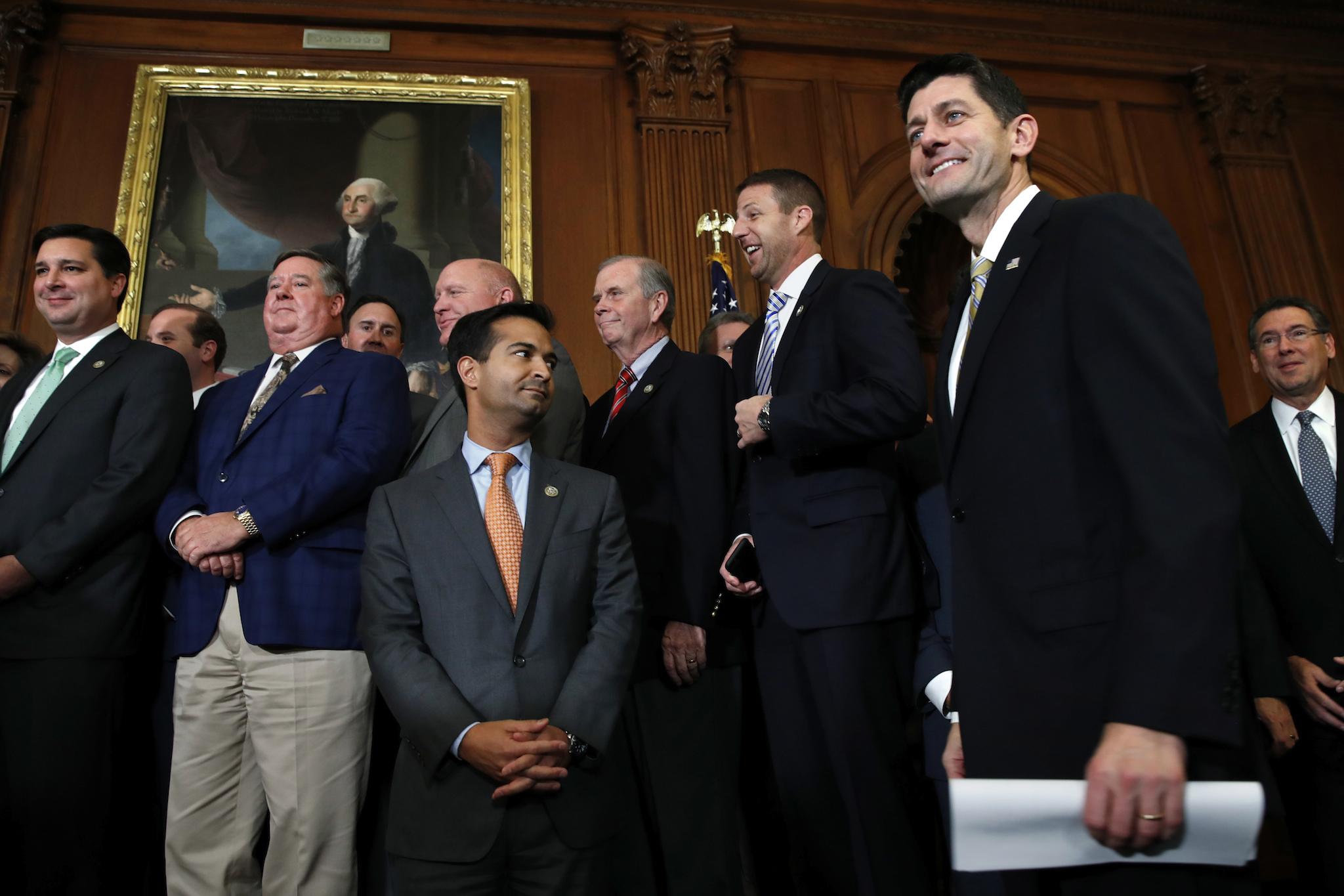 House Speaker Paul Ryan smiles as he arrives to speak to the media with House Republicans following passage of the GOP tax overhaul (AP Photo/Jacquelyn Martin)