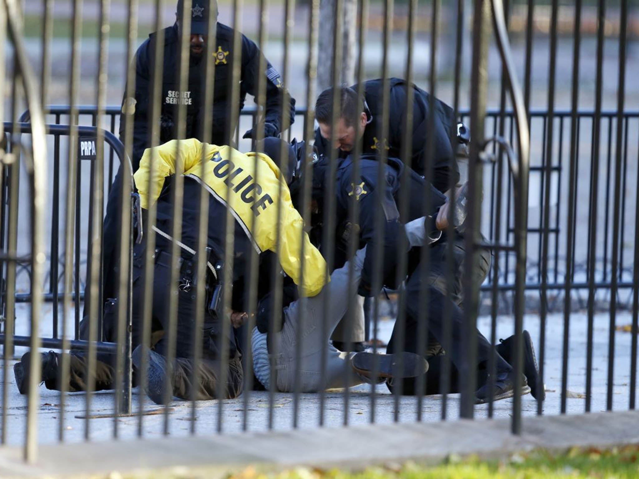 The man is subdued by the Secret Service after leaping the barrier at the White House