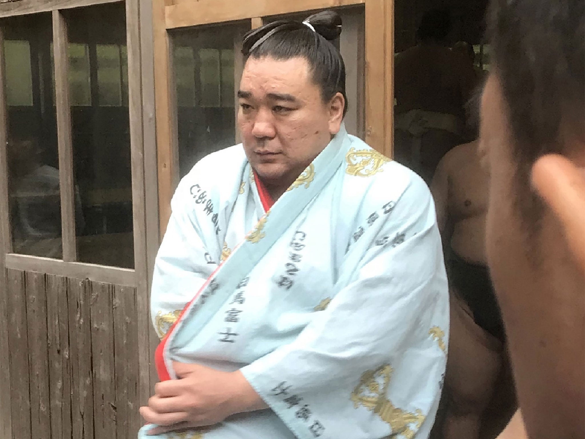 Mongolian sumo wrestler yokozuna, or grand champion, Harumafuji speaks with journalists