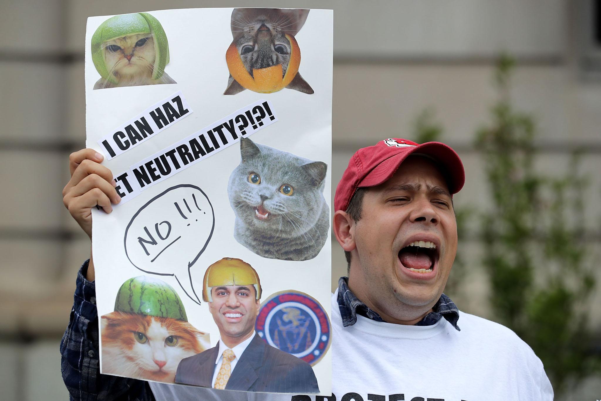 Proponents of net neutrality protest against Federal Communication Commission Chairman Ajit Pai outside the American Enterprise Institute before his arrival May 5, 2017 in Washington, DC