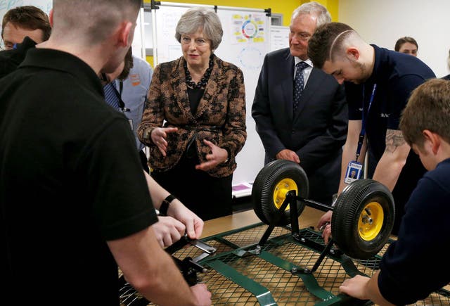 Britain's Prime Minister Theresa May visits an engineering training facility in Birmingham, central England, on November 20, 2017